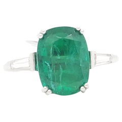 Emerald Oval and White Diamond Three Stone Ring in Platinum