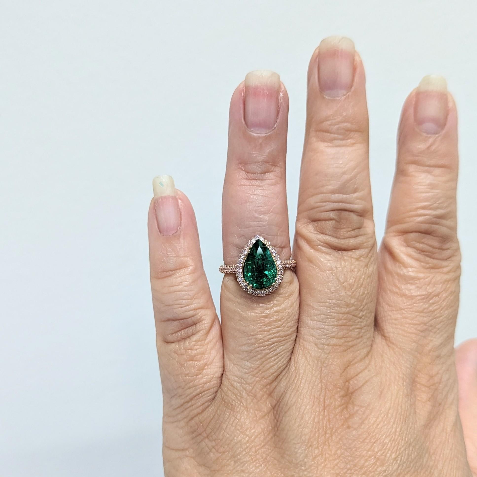 Beautiful 4.25 ct. emerald pear shape with 0.50 ct. natural pink diamond rounds.  Handmade in 18k rose gold.  Ring size 6.5.