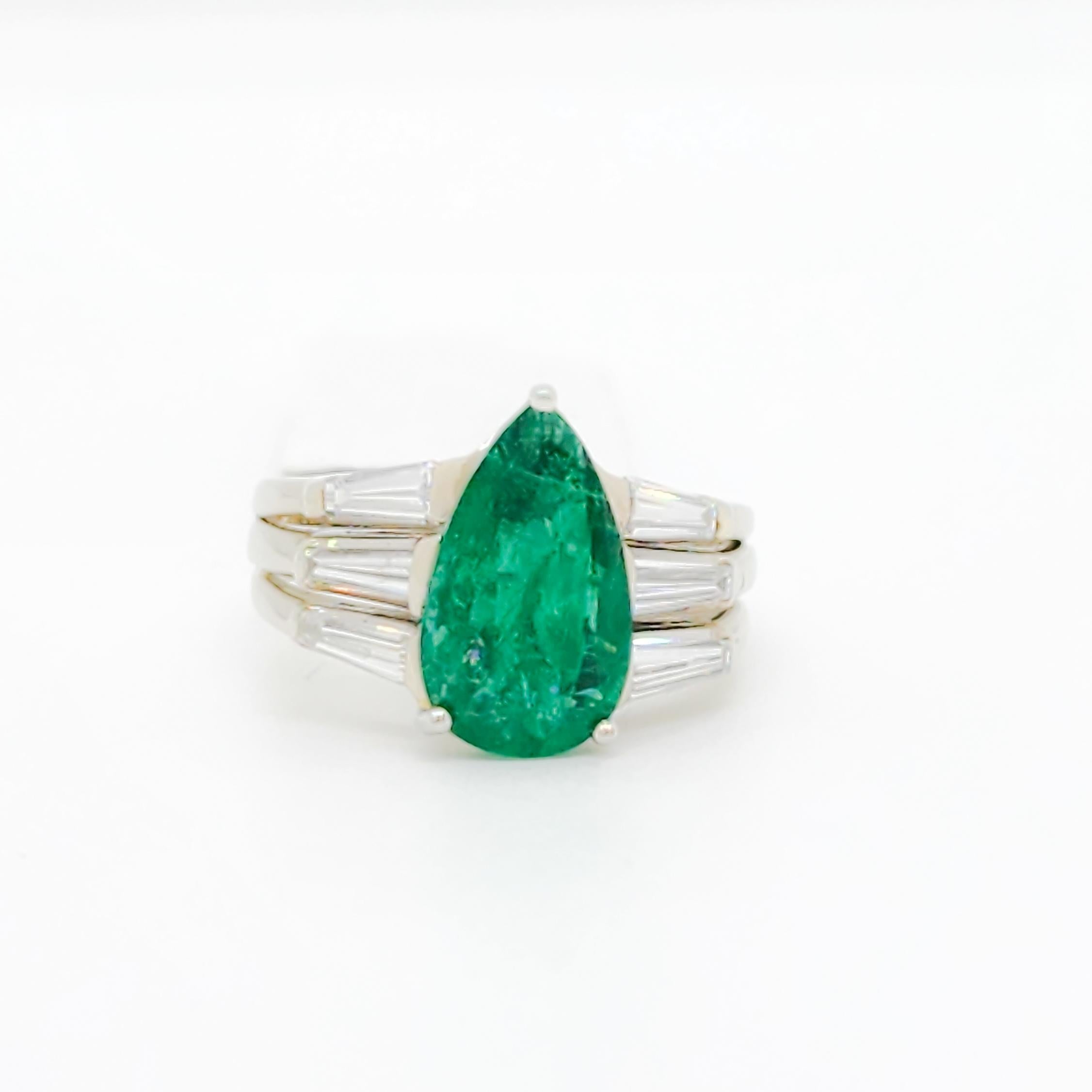 Beautiful 3.22 ct. emerald pear shape with 1.00 ct. good quality, white, and bright diamond baguettes.  Handmade in 18k white gold.  Ring size 8.