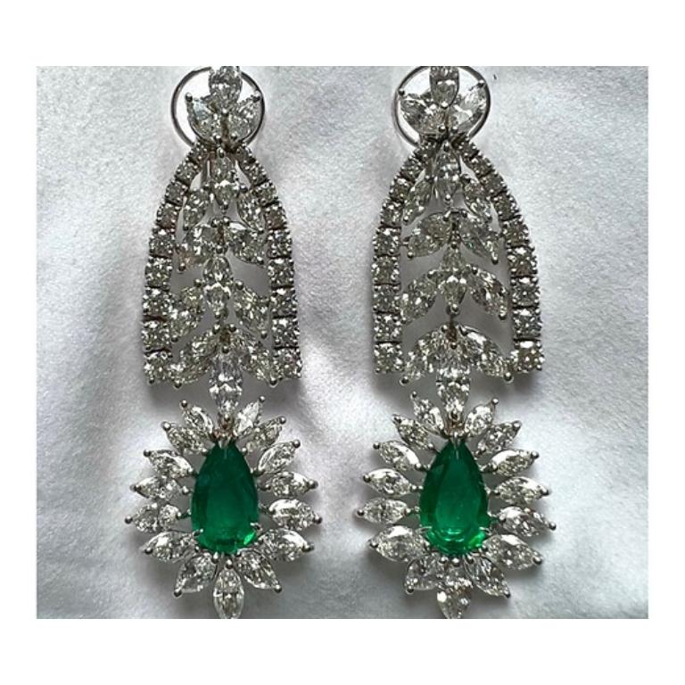 Emerald Weight: 4.76 CTS, Diamond Weight: 16.93 CTS (13.76 carat marquise and 3.17 carat rounds), Metal: 18K White Gold, Length: 2.5 Inches, Shape: Pear, Color: Vivid Green, Hardness: 7.5-8, Birthstone: May