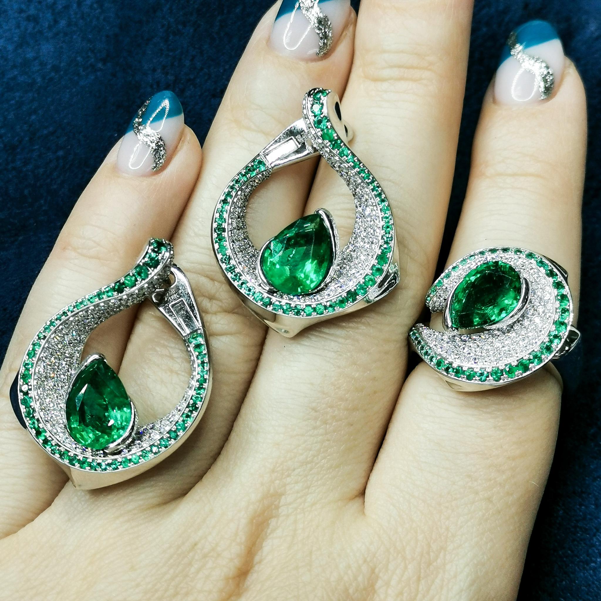 Emerald Pear Shape 6.25 Carat Diamonds Emeralds 18 Karat White Gold Suite
Contrasting colors are always eye-catching. Our new Suite is one of those. Bright Pear-shaped Emeralds rests on a snow-white plateau of  Diamonds, which are framed by a line