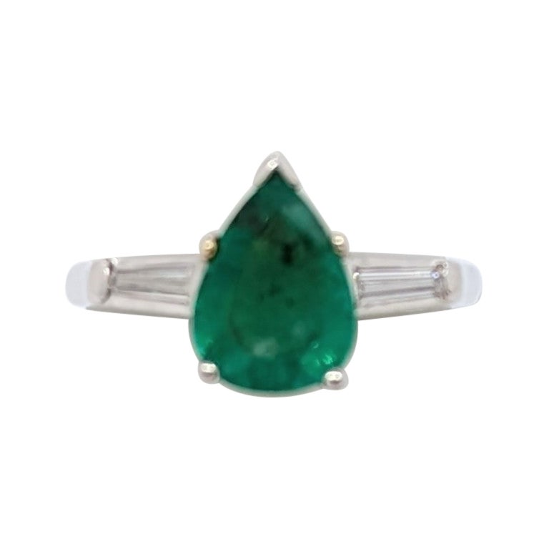 Emerald Pear Shape 
White Diamond Baguette Three Stone Ring in Platinum