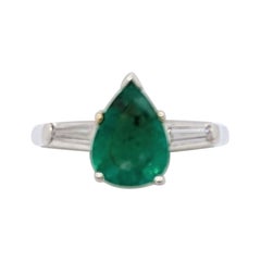 Emerald Pear Shape 
White Diamond Baguette Three Stone Ring in Platinum