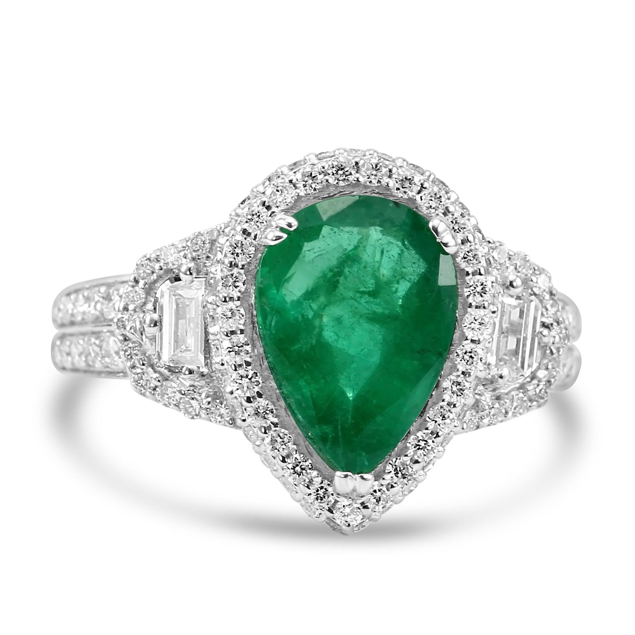 Behold the epitome of timeless elegance with our Pear shaped Emerald ring, featuring a breathtaking Pear-Shaped Emerald at the center, weighing an impressive 2.38 carats. This mesmerizing gem is flanked by two Pear-Shaped White Diamonds, totaling