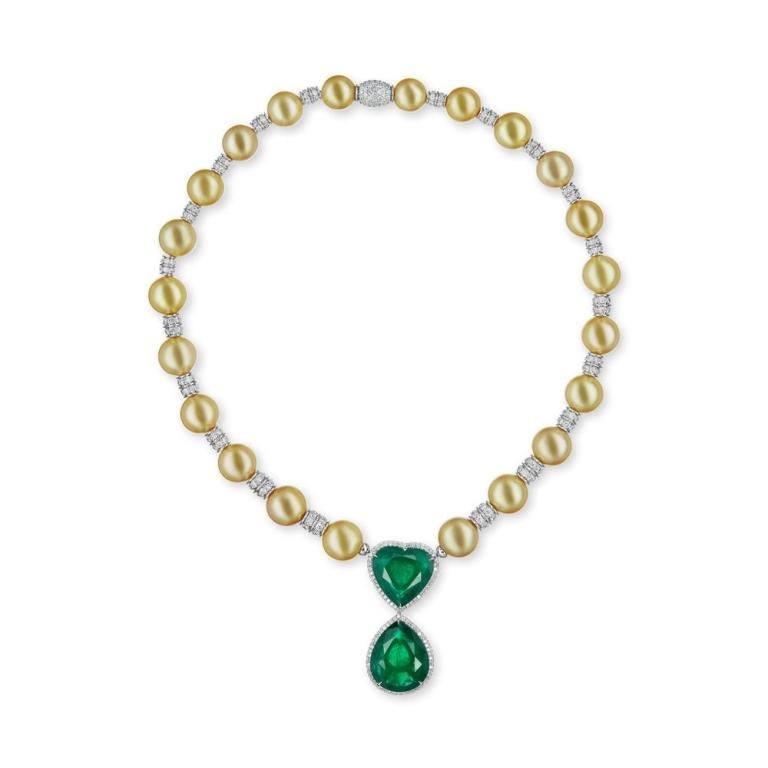 EMERALD/PEARL AND DIAMOND NECKLACE Luminous Golden South Sea pearls and diamond beads give life to this elegant necklace on which 2 vivid green Emeralds are featured (1 Heart shaped and the other Pear shaped) Item: # 03107 Metal: 18k W / Y Lab: Grs