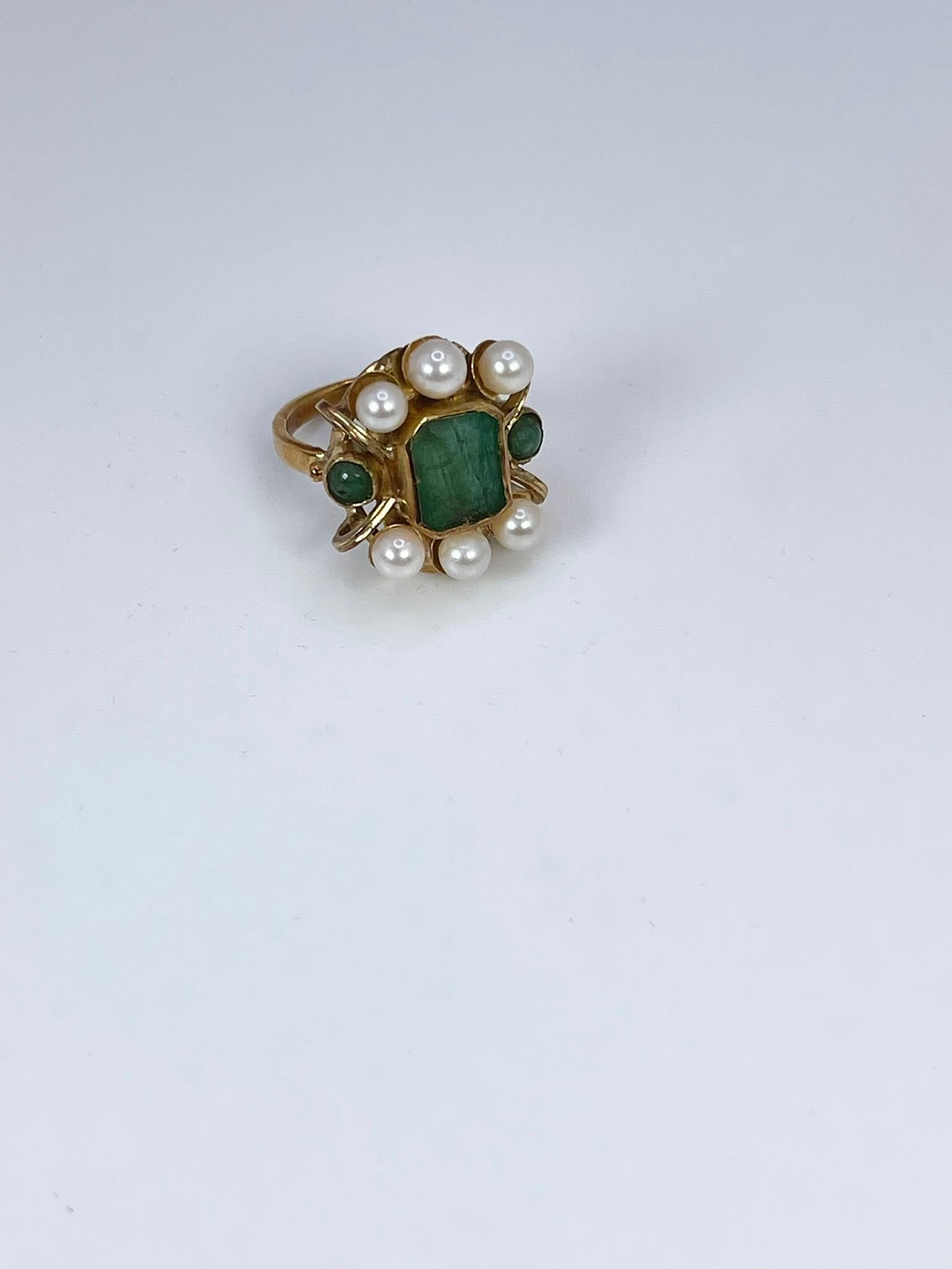 
Handmade cocktail ring made with natural emeralds and pearls in 14KT yellow gold.

GRAM WEIGHT: 6.52gr
GOLD: 14KT yellow gold
NATURAL EMERALD(S)
Clarity/Color: Heavily Included/Green
NATURAL PEARL(S)
Color/Clarity: White/Slightly Blemished
Size:
