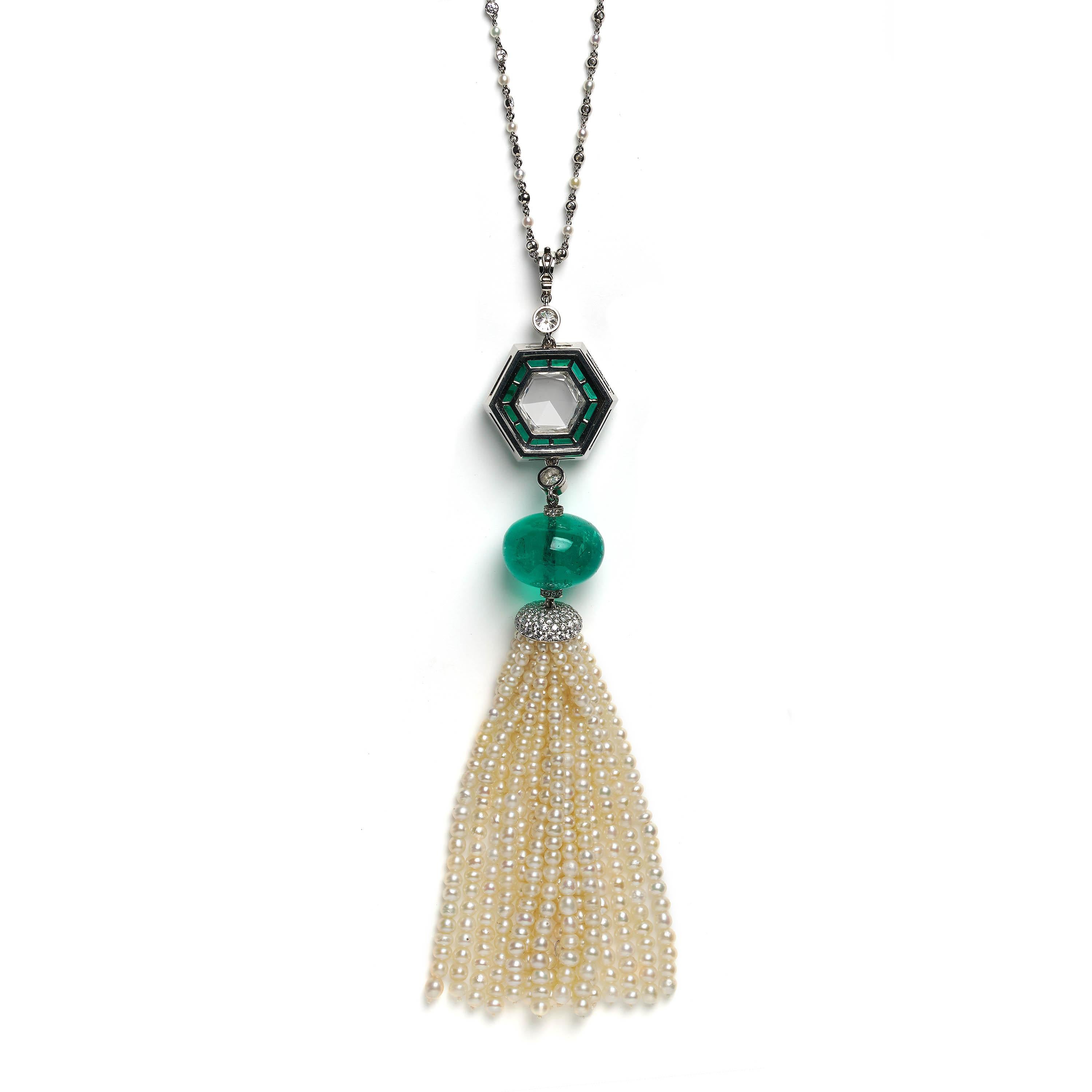 A modern drop pendant necklace, consisting of a fringed tassel made up of an estimated 69.20 carats of white pearls, with a brilliant-cut diamond set cap, suspended by a polished emerald bead weighing an estimated 28.81 carats, above which is a