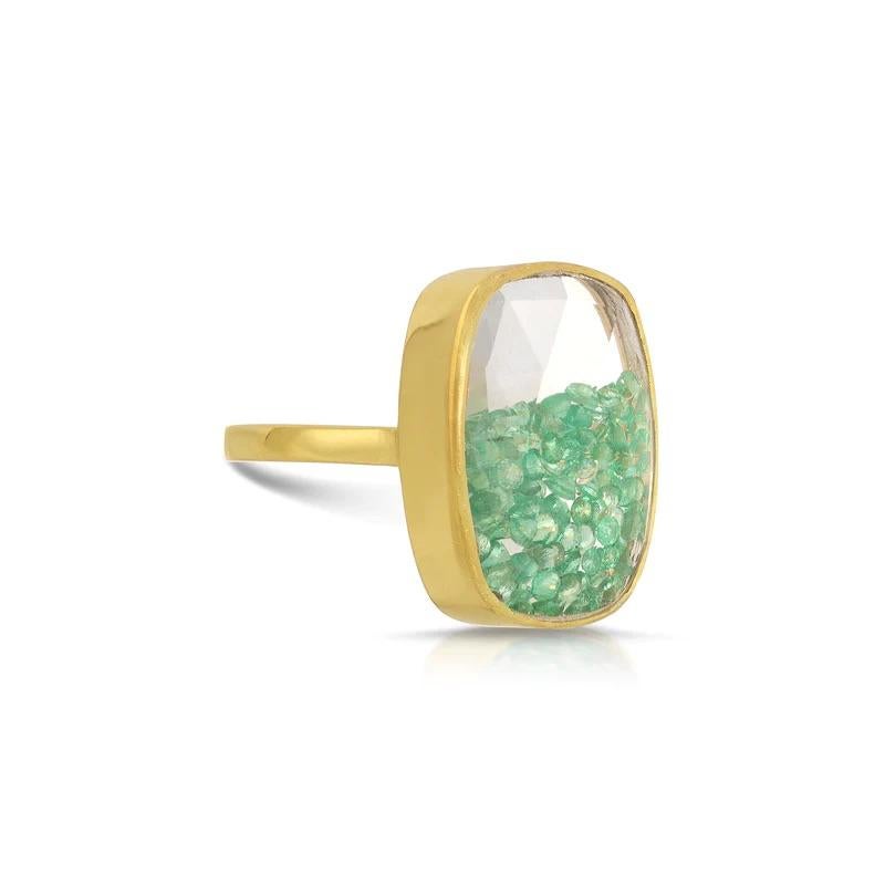 Emerald Glitter Globe Ring. A fabulous stylish cocktail ring featuring a luminescent shimmering mass of glittering fluid green emeralds encased in a checker cut carved crystal rectangular dome. 

- Natural green emeralds .90 carats.
- Set in 22