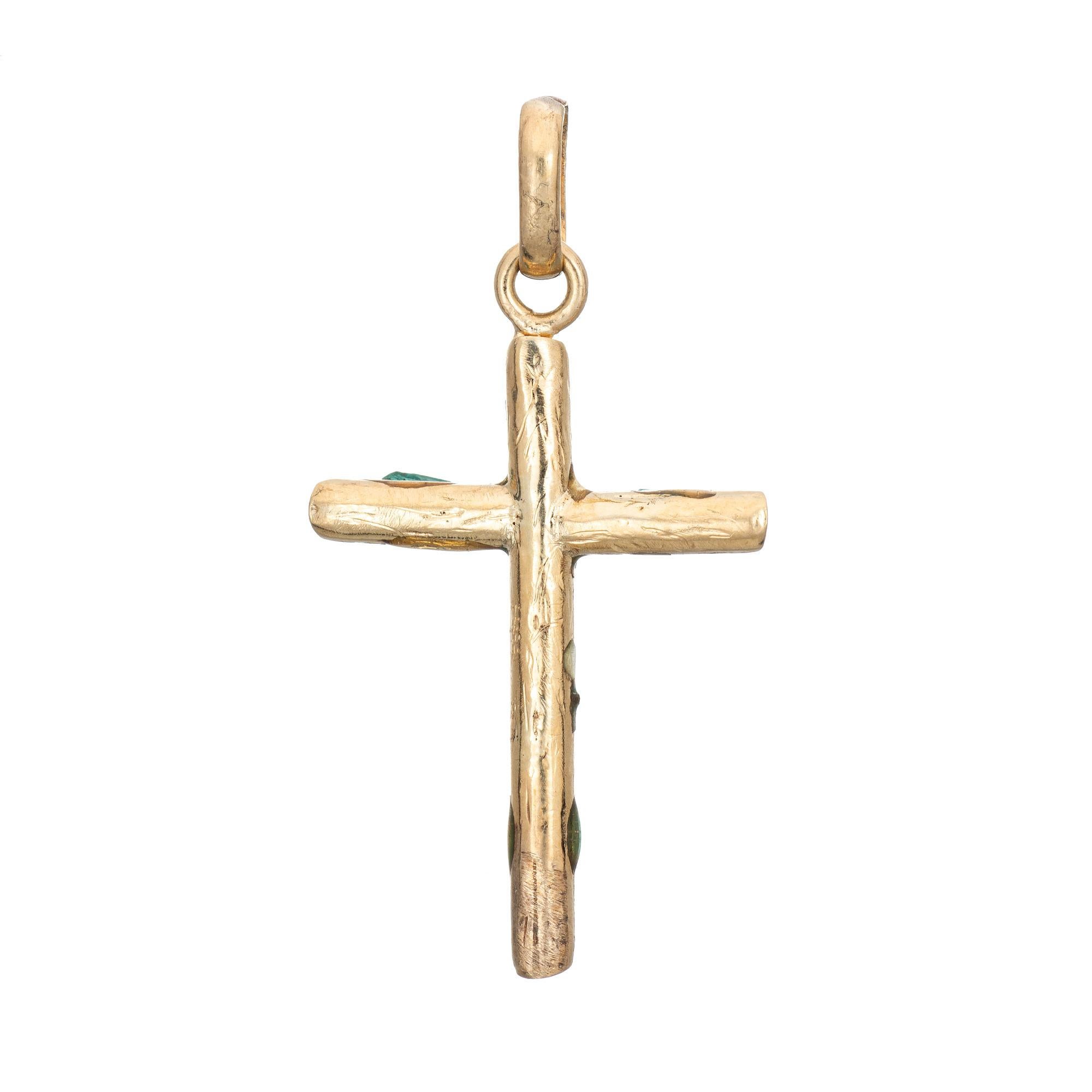 Finely detailed vintage emerald cross pendant crafted in 18 karat yellow gold (circa 1970s to 1980s). 

Emerald cut emeralds measure (average) 4mm x 3mm and total an estimated 1.50 carats. Note: few chips to the emeralds (visible under a 10x