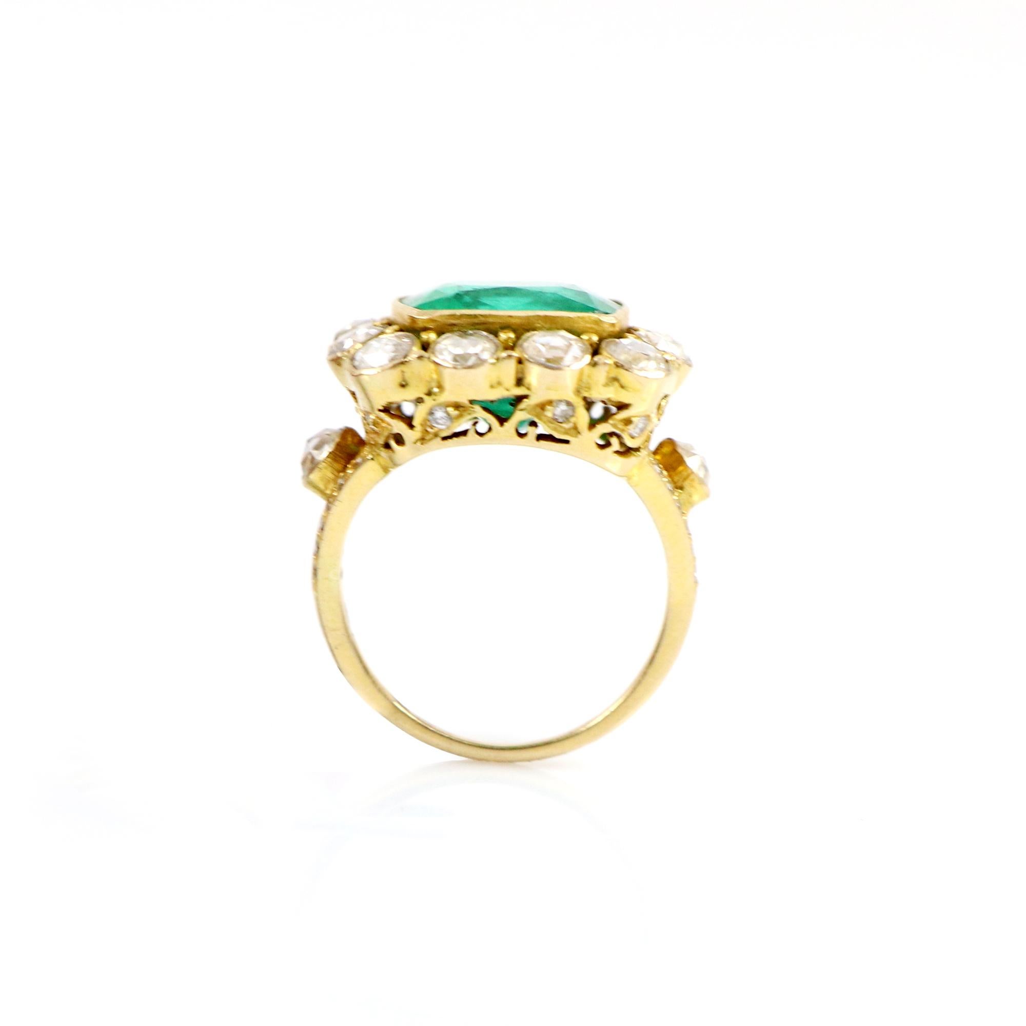 This is a classic cocktail/fashion 18k Gold Ring Studded with African Emerald and Rose Cut Diamonds around in a halo. You can also find two rose cut diamonds on the sides of the band to elevate the look, the ring band splits into two to hold and