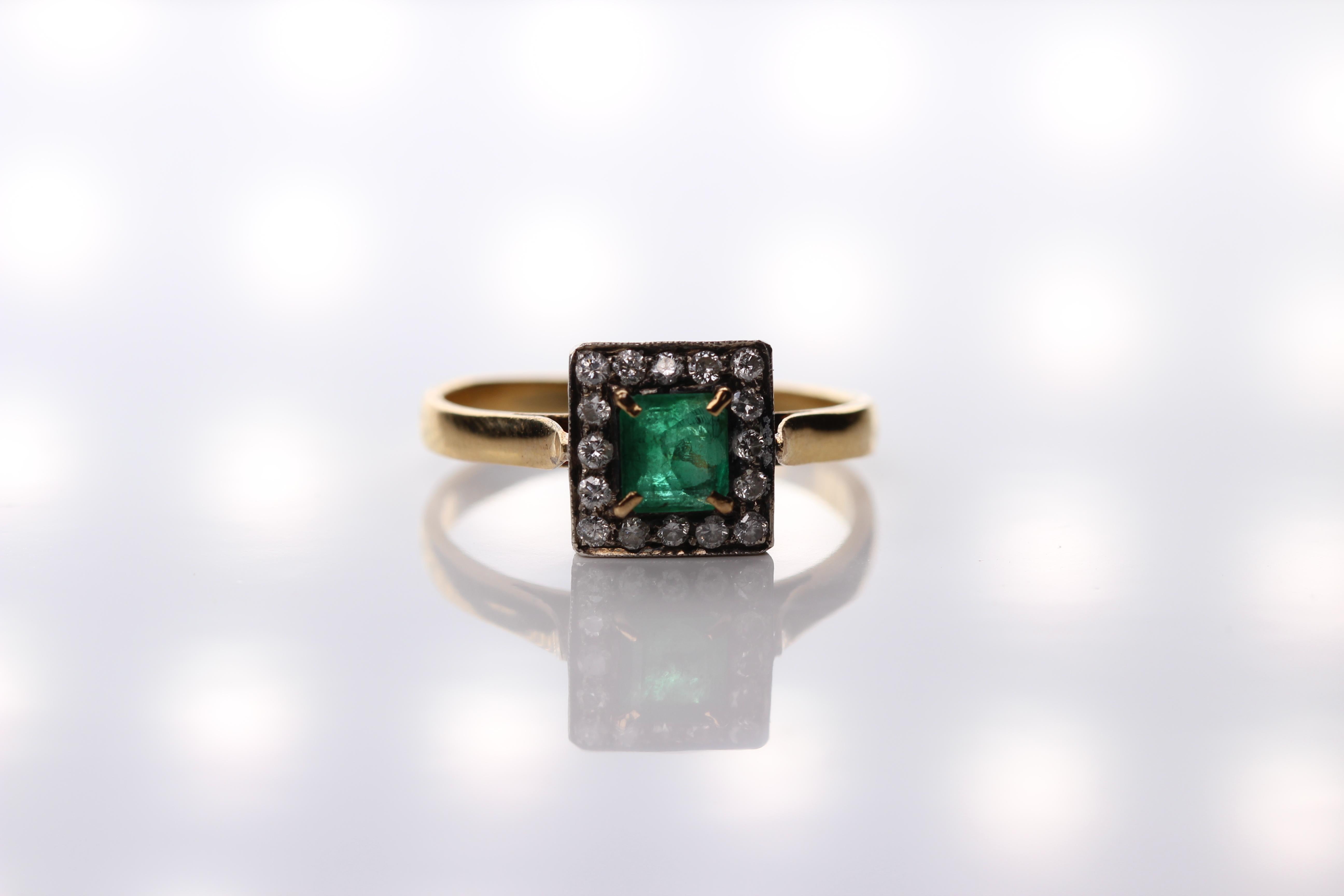emerald ring surrounded by diamonds