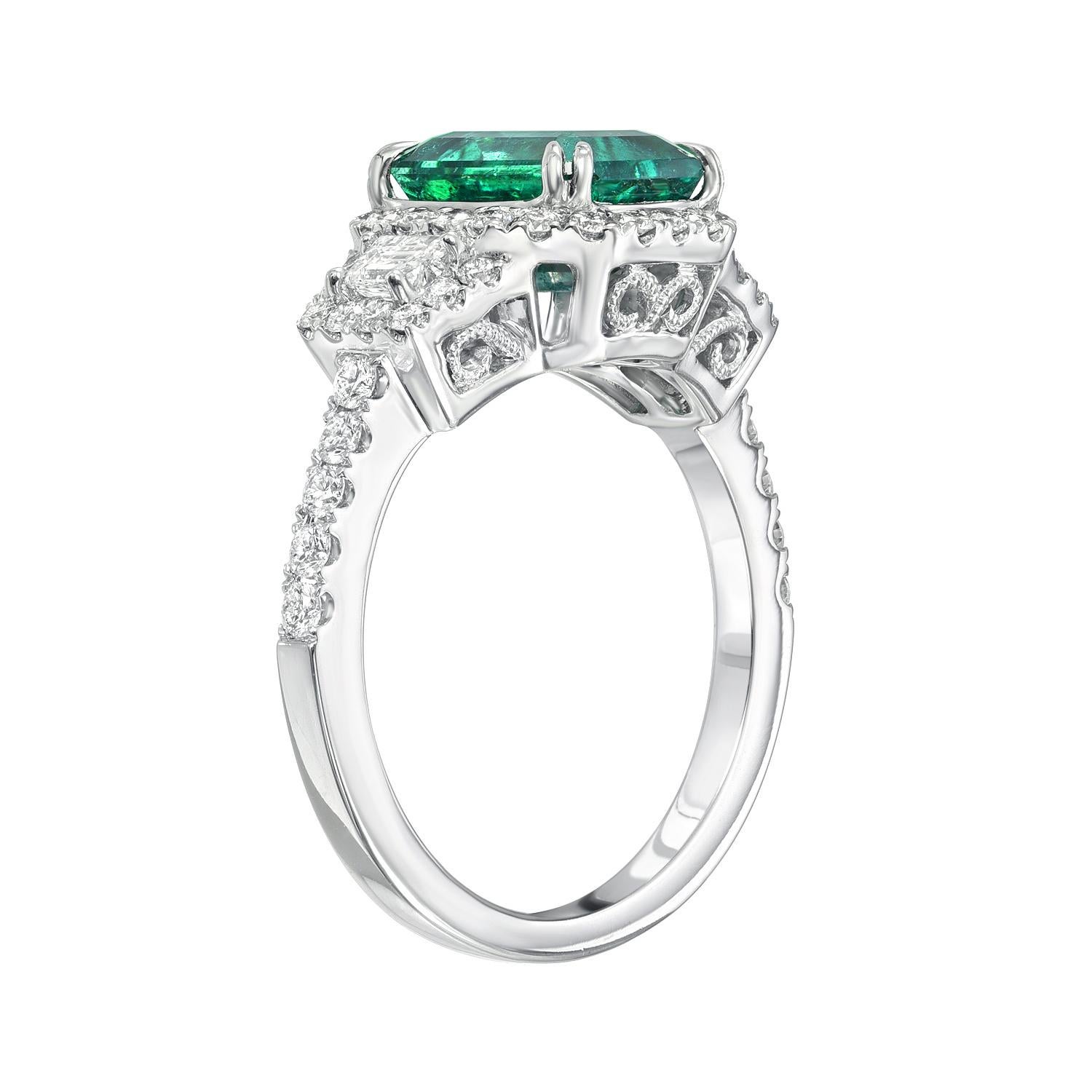 Classic 2.16 carat emerald-cut Emerald, 18K white gold ring, flanked by a pair of trapezoid diamonds and round brilliant diamonds weighing a total of 0.80 carats. 
Ring size 6.5 Resizing is complementary upon request.
Crafted by extremely skilled