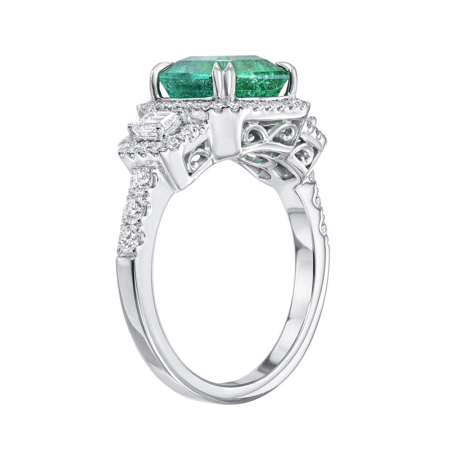 Opulent green 2.50 carat Emerald ring in 18K white gold, flanked by a pair of emerald cut diamonds and surrounded by round brilliant diamonds weighing a total of 0.83 carats.
Size 6.5. Re-sizing is complimentary upon request.
Returns are accepted