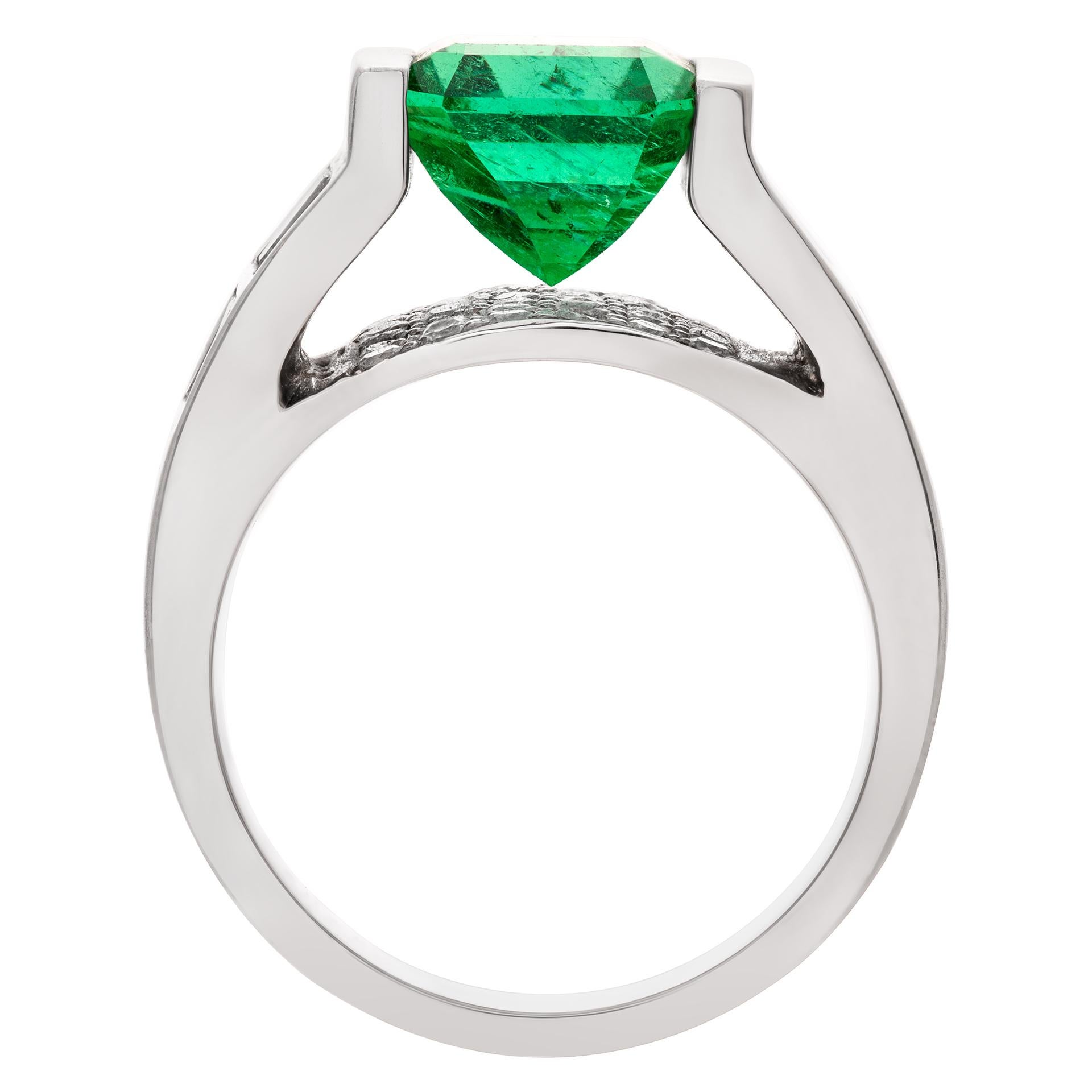 ESTIMATED RETAIL: $16,000.00  YOUR PRICE: $9,060.00 Gorgeous tension set emerald ring in 14k white gold with an app. 3.16 ct green emerald with approximately 1.05 carats in diamonds accents. Size 6.

