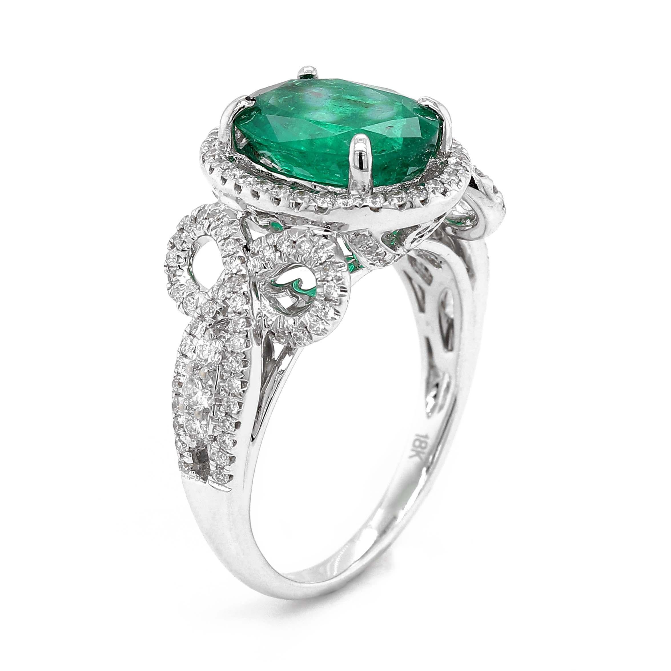 Ring containing one fine oval shape Emerald of about 2.42 carats measuring 10.22x7.85x4.67mm. The emerald is surrounded by 140 round brilliant cut Diamonds of about 0.51 carats with a clarity of SI and color G. All stones are set in an 18k white