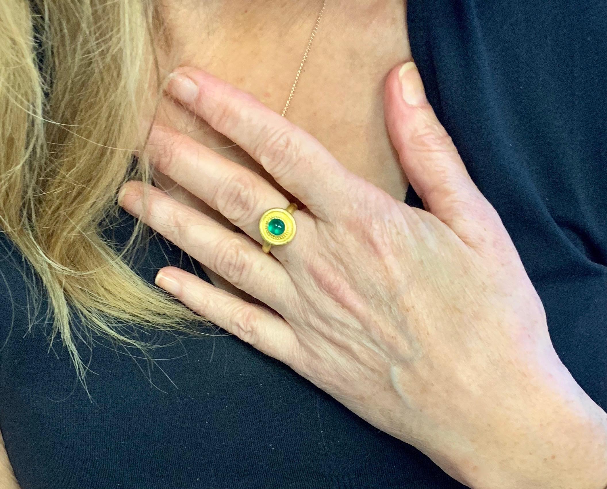 Oval cabochon Emerald ring,  granulation in 22 Karat gold. 
Emerald with its fresh spring color is well suited to represent the birthstone of May.
Size 7-7.25 emerald is 1.25 carats. This ring can be resized.
One of a kind and  hand made in New York