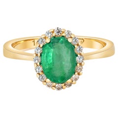 Emerald ring with diamond halo.