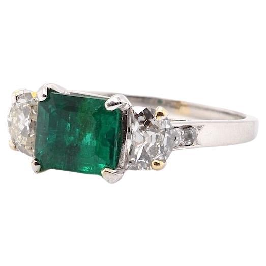 Emerald ring with half-moon diamonds