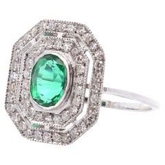 Emerald ring with surrounding diamonds