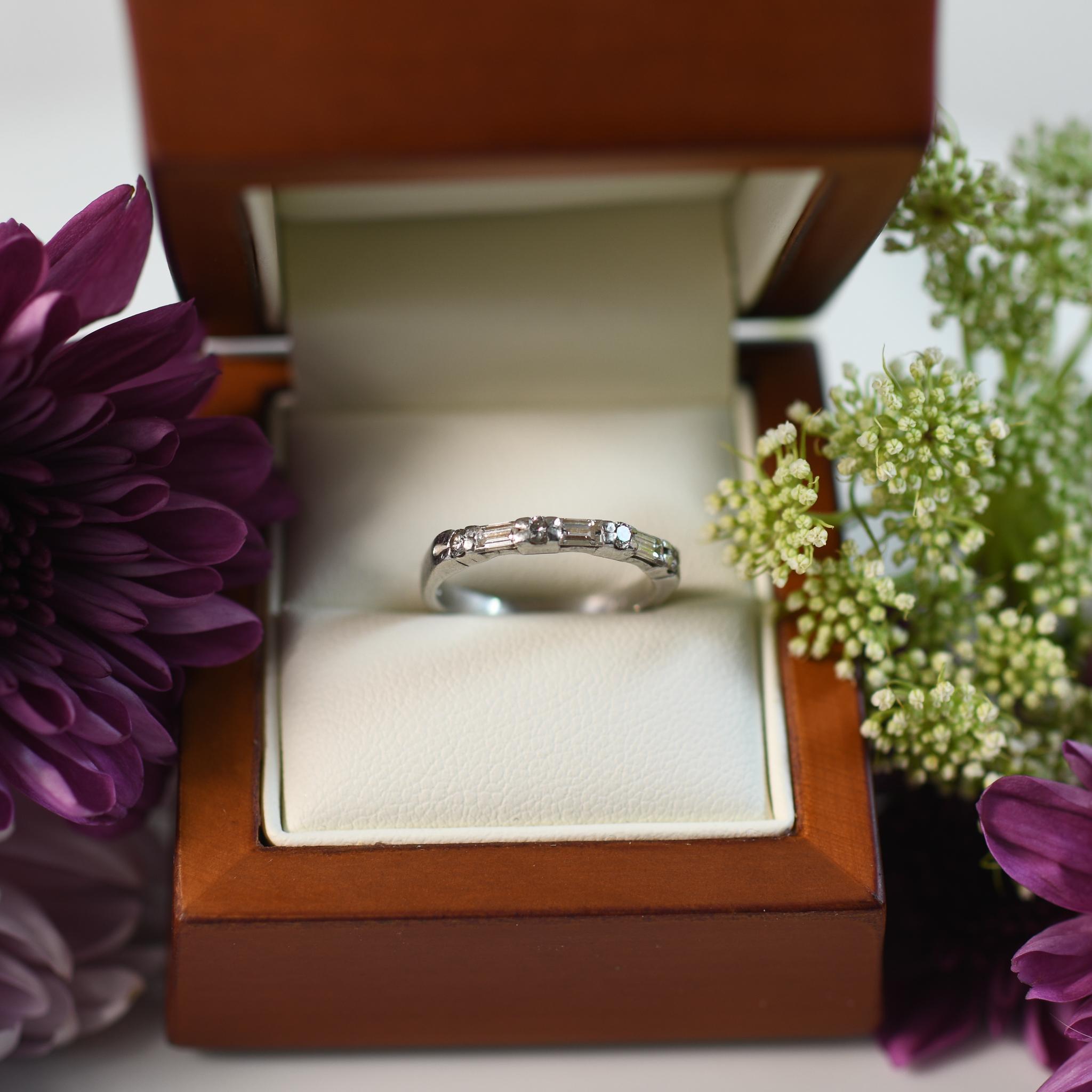 Elevate your style with this exquisite diamond band, meticulously crafted in platinum to radiate timeless sophistication. The band features four round brilliant diamonds, totaling 0.10 carats, and three emerald-cut diamonds, totaling 0.30 carats,