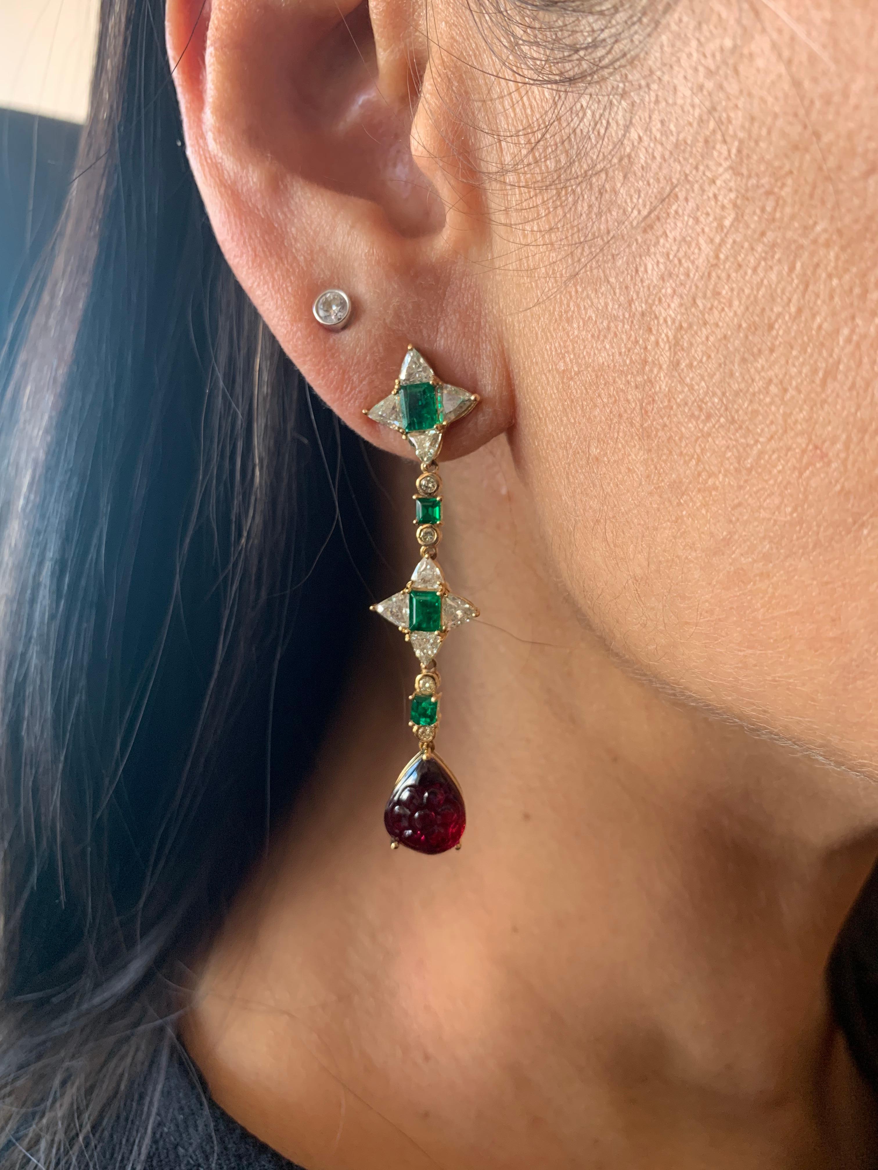 Elegant emerald and rubelite dangling earrings that are fun to wear. Crafted using a mix of unique cuts and shapes, these earrings are inspired by art deco and mughal elements. The pop of color with a trendy design makes these an eye-catching pair