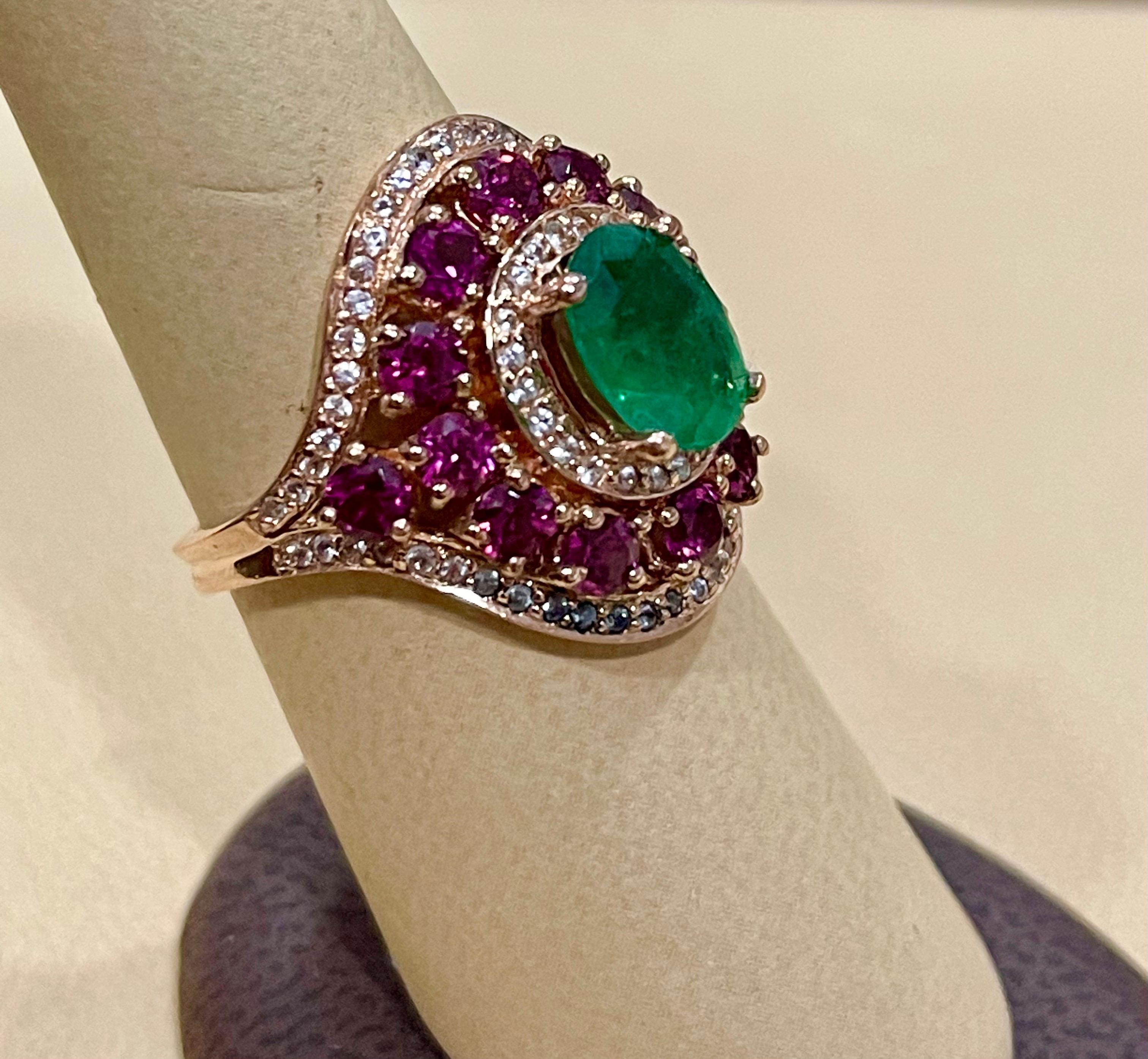 Emerald , Rubellite & Diamond Cocktail Ring in 14 Karat Rose Gold Size 8
Approximately 2 ct Oval Emerald of fine quality with excellent color and brilliance.
Round Brilliant cut diamonds are surrounding the center stone emerald.
The next row is made