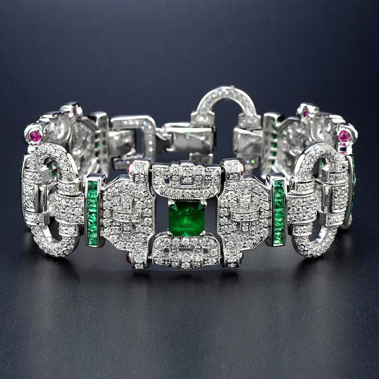 The Gorgeous Art Deco Style 18k White Gold Bracelet set with 1 pcs. Emerald 1.5 Carat and French Cut Emerald 50 pcs. 3.35 Carat. Small Cabochon Ruby 12 pcs. 0.8 Carat and 636 pcs. round cut Diamond 7.99 Carat. 

The length of this Bracelet is around