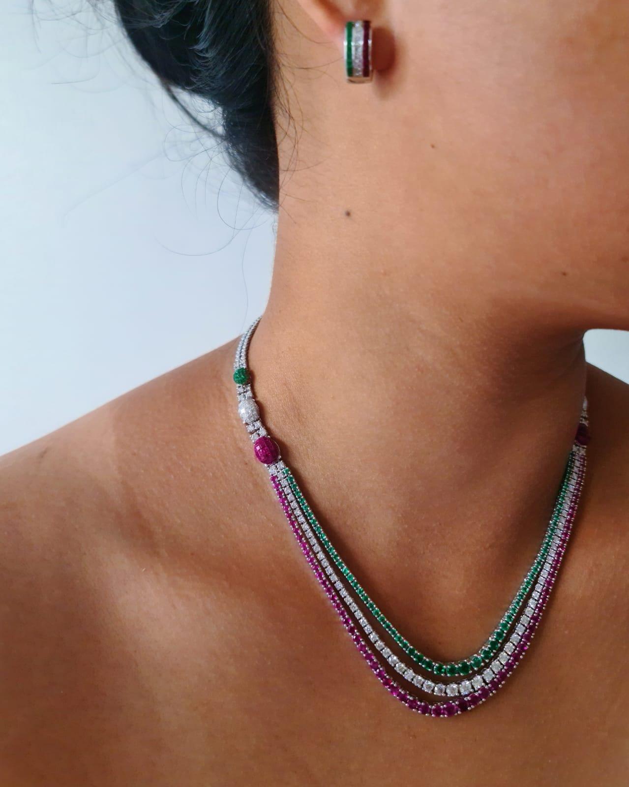 A three line necklace of emerald, ruby, and diamond. The total ruby weight is 8.02 carats, emerald weight is 3.87 carats, diamond is 6.00 carats. The total weight is 39.33 grams. 