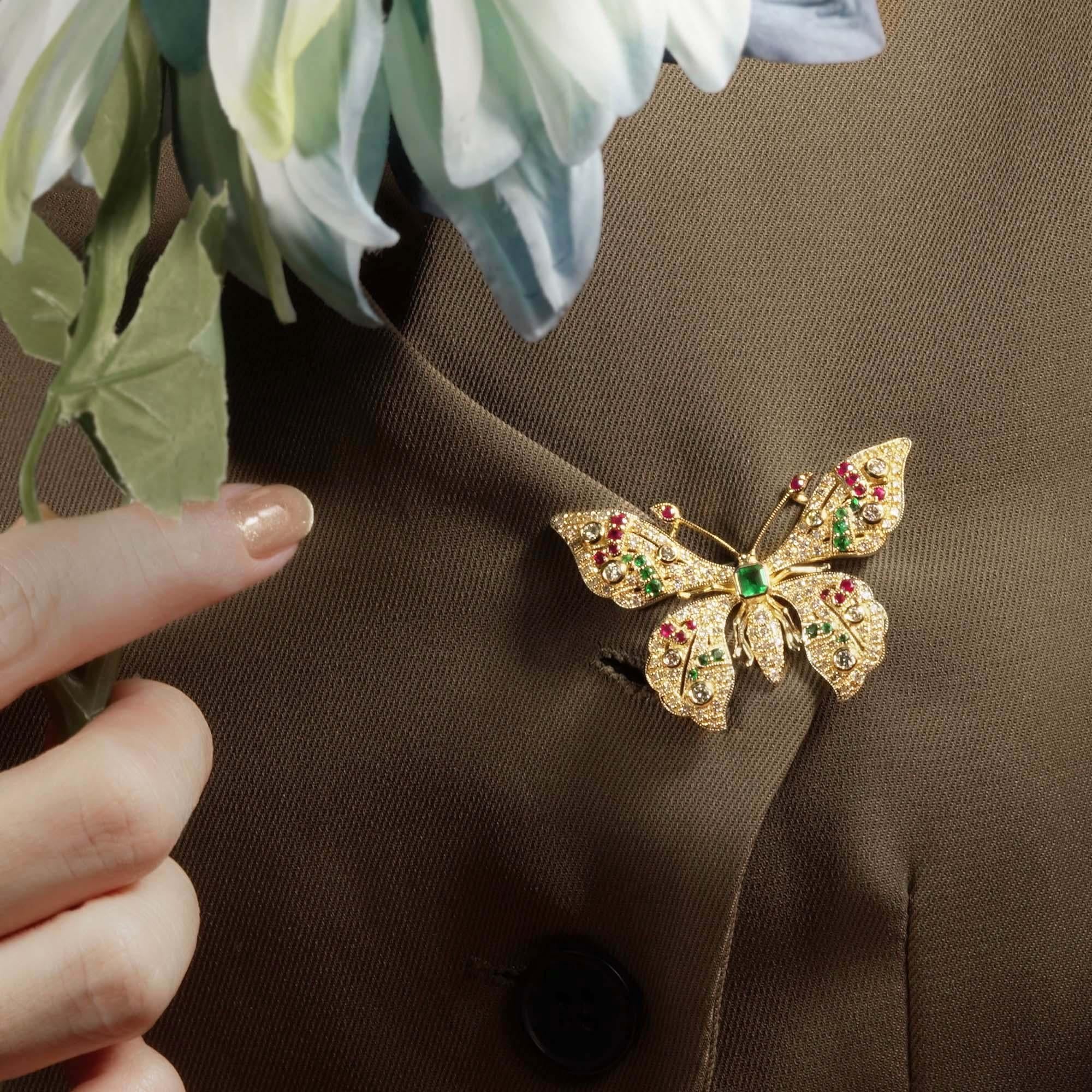 The elegance of nature with its intricate design. The butterfly's body is adorned with a rich emerald, symbolizing vitality and grace. Ruby accents elegantly line the antennae and petals, adding a touch of fiery passion. The delicate wings are