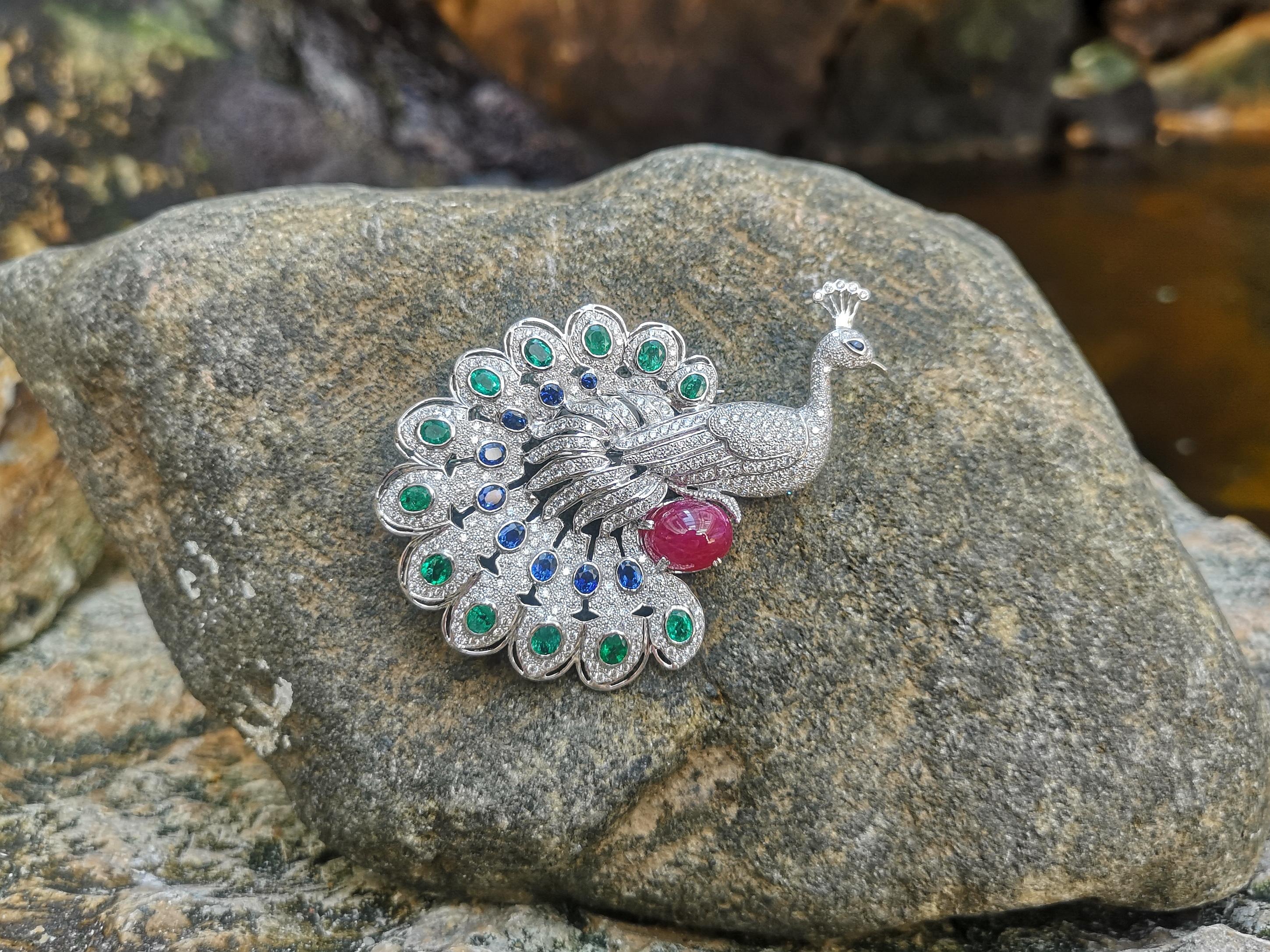 Emerald 3.79 carats, Cabochon Ruby 8.62 carats, Blue Sapphire 2.97 carats and Diamond 4.51 carats Brooch set in 18 Karat White Gold Settings

Width:  5.5 cm 
Length: 7.5 cm
Total Weight: 31.83 grams

