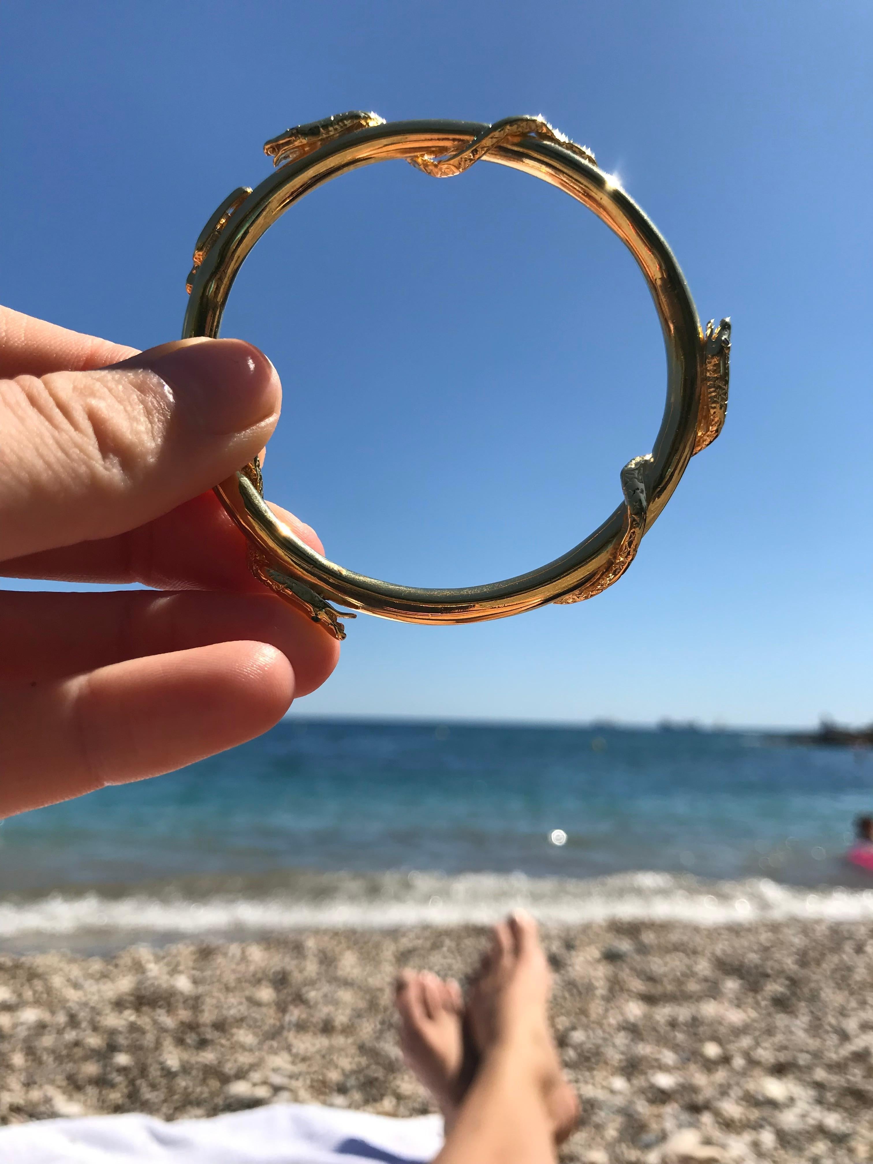 Snake Bangle Bracelet Emerald Ruby Blue Sapphire Gold Plated Brass J Dauphin

J DAUPHIN Bangle Arm Cuff with 3 snakes having eyes set with Emeralds ( 2 ), Blue Sapphire ( 2 ) and Ruby (2 )

Historically, serpents and snakes represent fertility or a