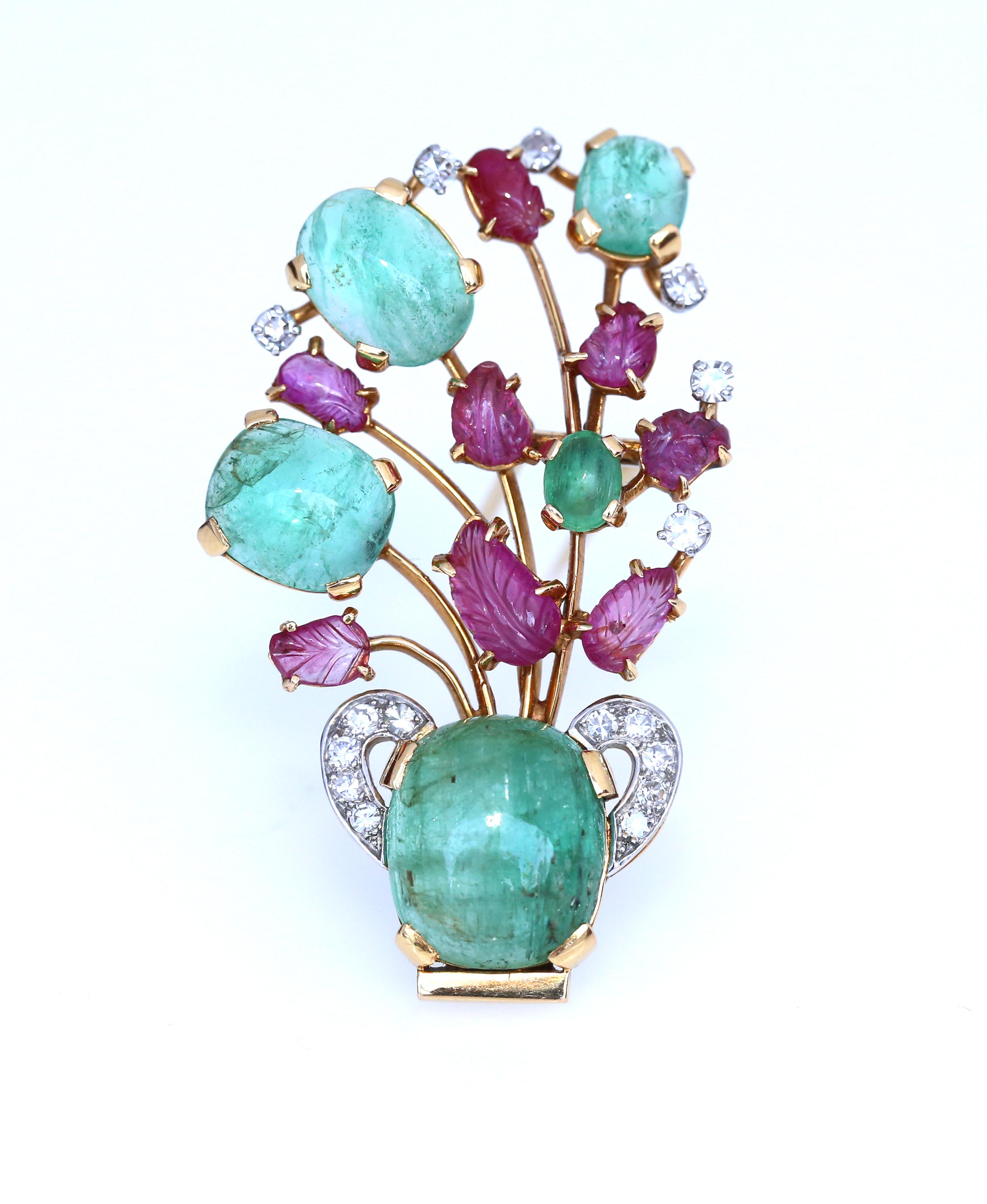 Fine brooch designed as a vase emitting a spray of flowers and set with cabochon Emeralds, carved Rubies and single-cut Diamonds, French assay and maker's marks. 1910. Formerly in the collection of Princess Thérésa Vatchnadzé, Née Beglarian, she