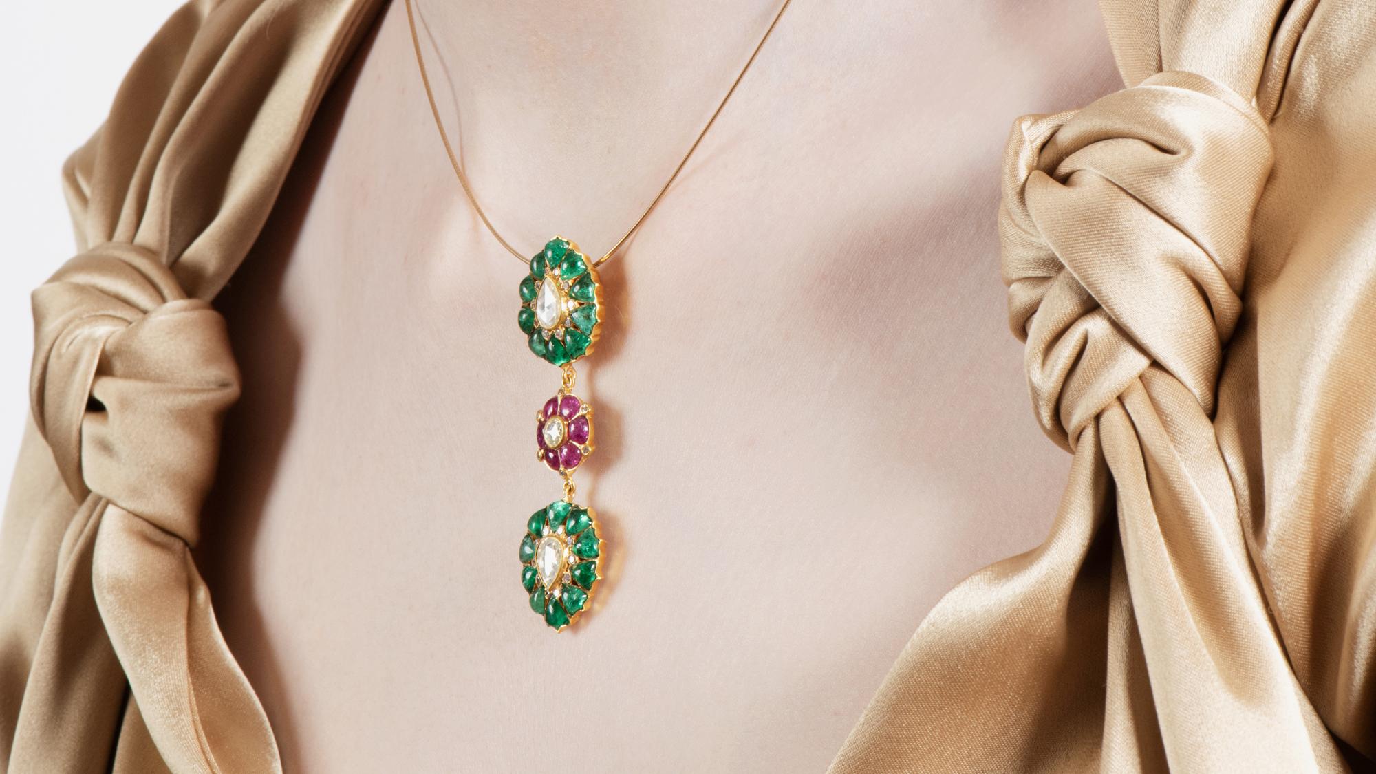Diamond weight: 0.35 carats
Rose-cut Diamond weight: 1.30 carats
Emerald weight: 6 carats 
Ruby weight: 1.80 carats

An homage to precious coloured stones - this exquisite pendant is handmade from 18k yellow gold and features a beautifully crafted