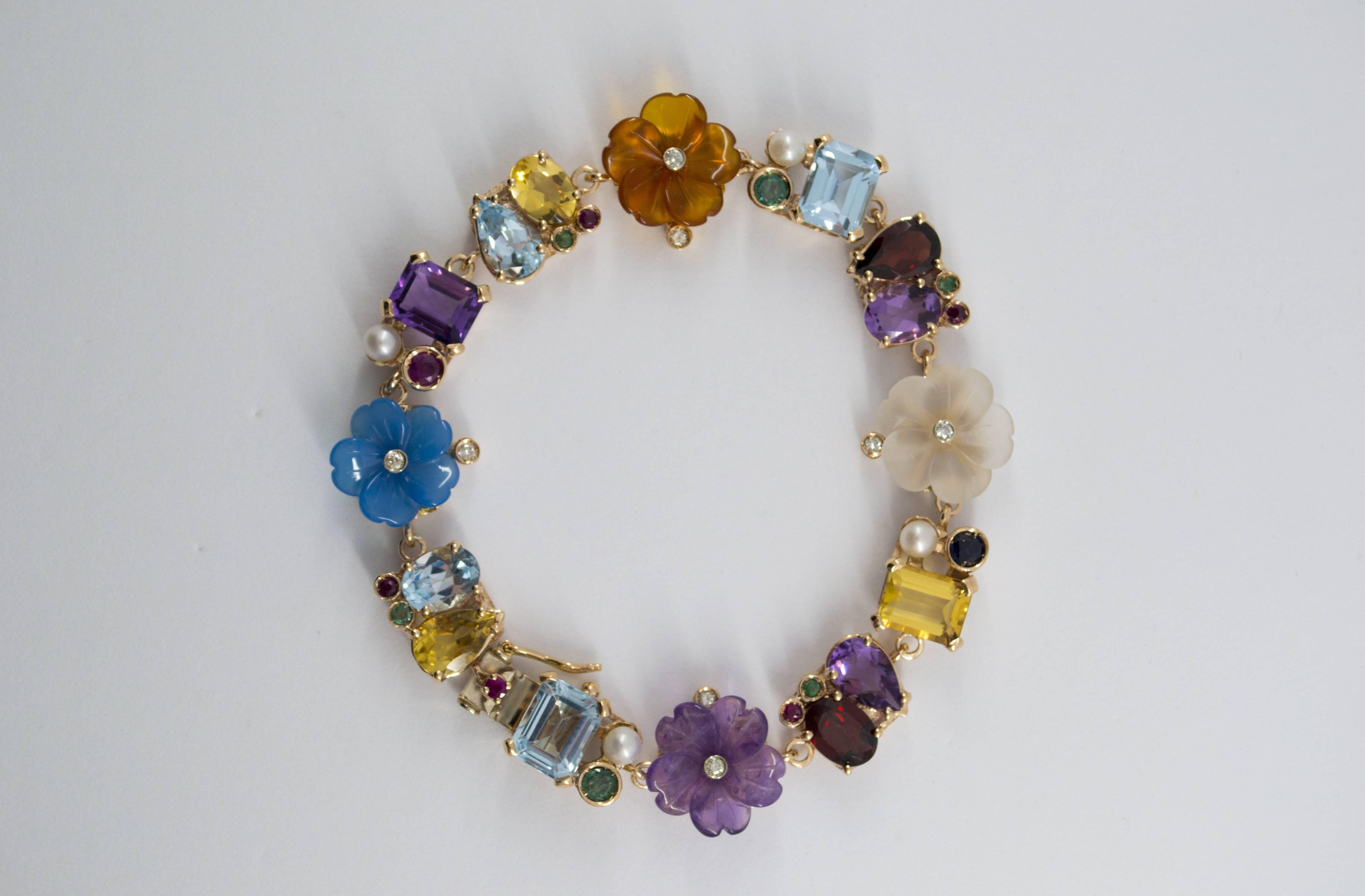 This Bracelet is made of 14K Yellow Gold.
This Bracelet has 0.20 Carats of White Diamonds.
This Bracelet has 0.90 Carats of Sapphires, Rubies and Emeralds.
This Bracelet has also Topaz, Amethyst, Citrine, Rock Crystal, Garnet, Agate, Pearl,