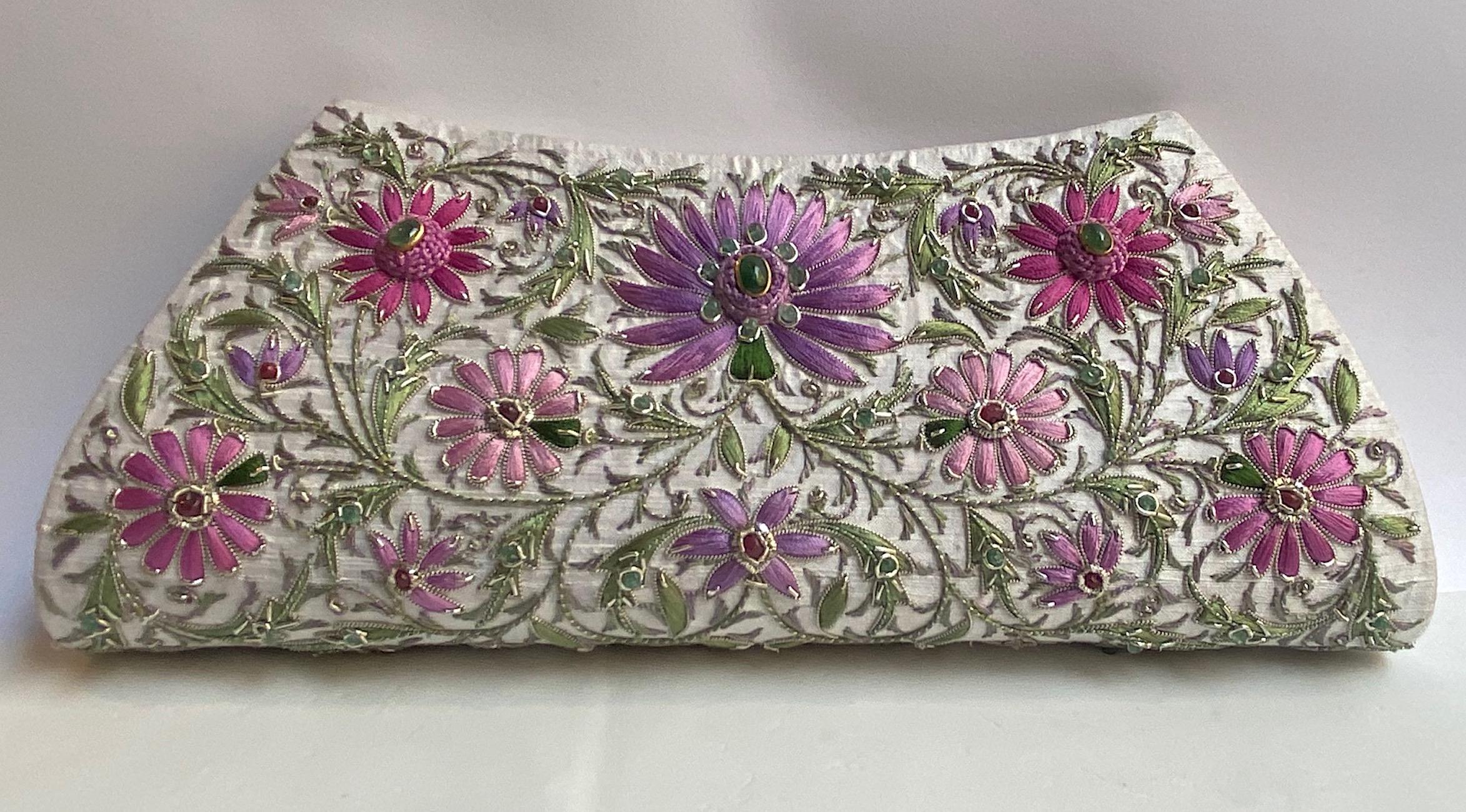 A beautiful and intricate hand embroidered evening bag from India. The use of gold and silver thread and precious jewels in embroidery is known as Zardozi and was once used to embellish the attire of the Kings and the royals in India. Egg shell, off