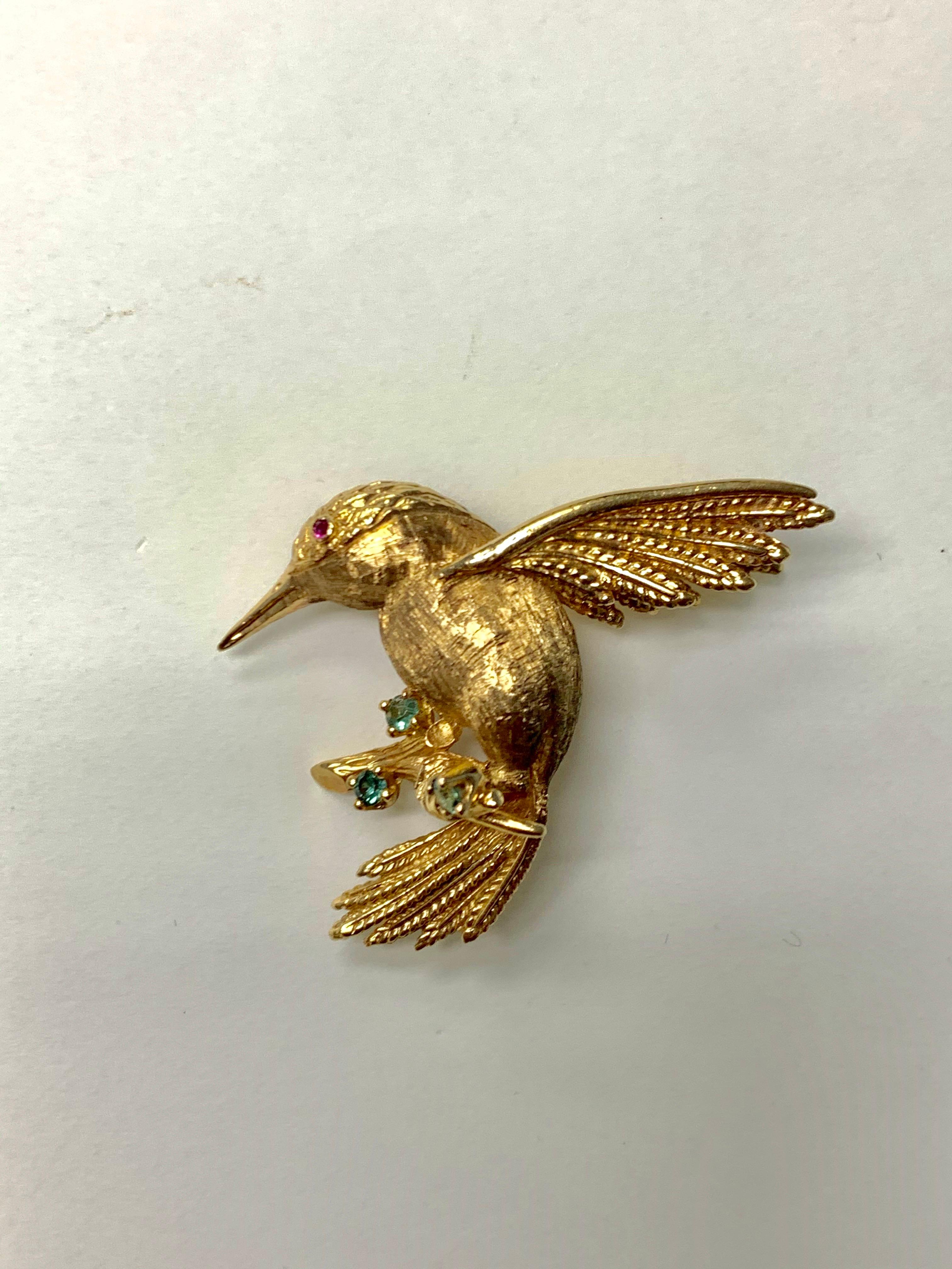 Emerald, ruby and 14k yellow gold bird pin. 
Gold weight : 15.4 grams 
Metal : 14k 
measurements : 1 1/2 inches by 2 inches

