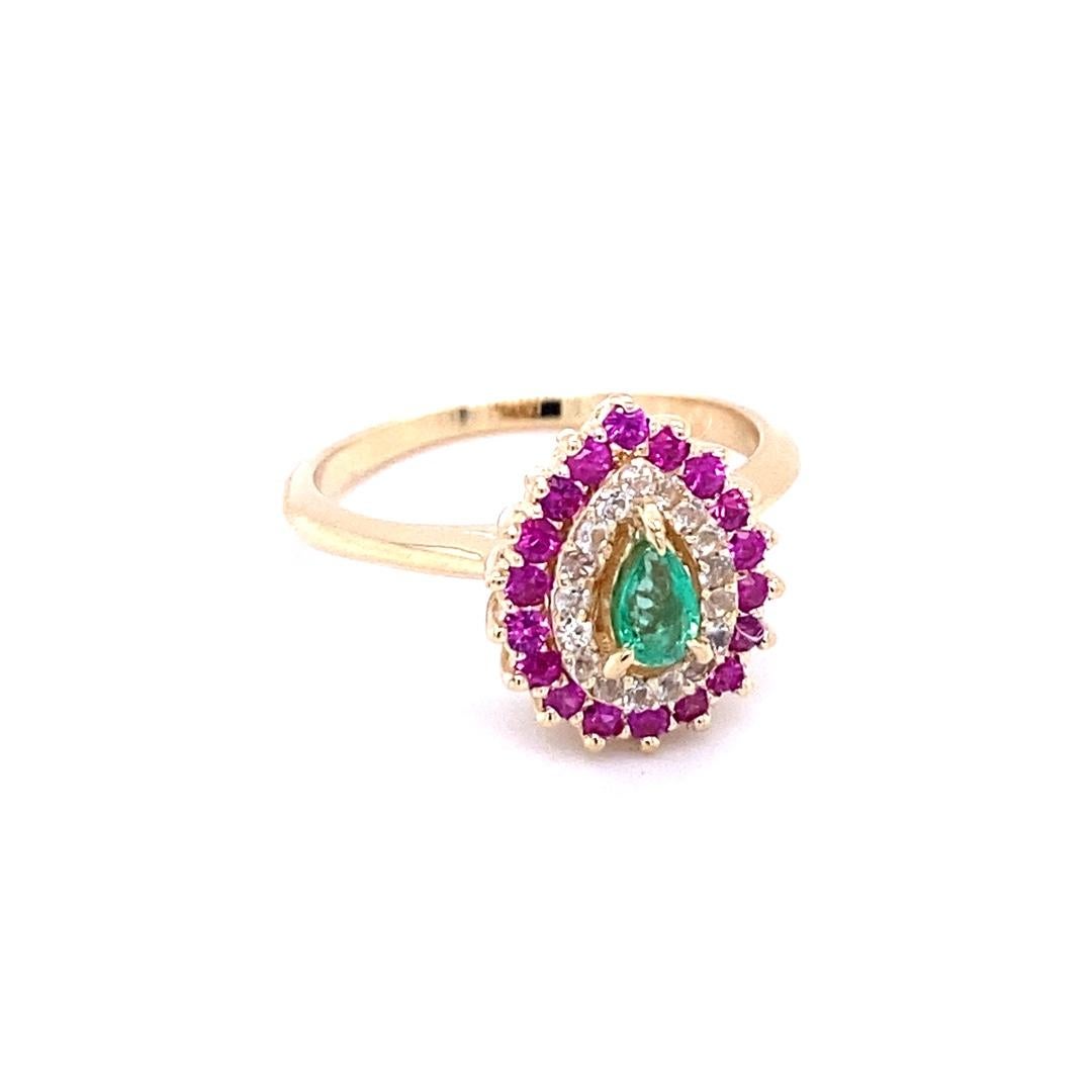 Emerald Sapphire 14 Karat Yellow Gold Cocktail Ring

Delicate and dainty Emerald sits in the center of the ring and is surrounded by a cluster of Pink and White Sapphires.

The carat weight of the stones are as follows:

Pear Cut Emerald = 0.15