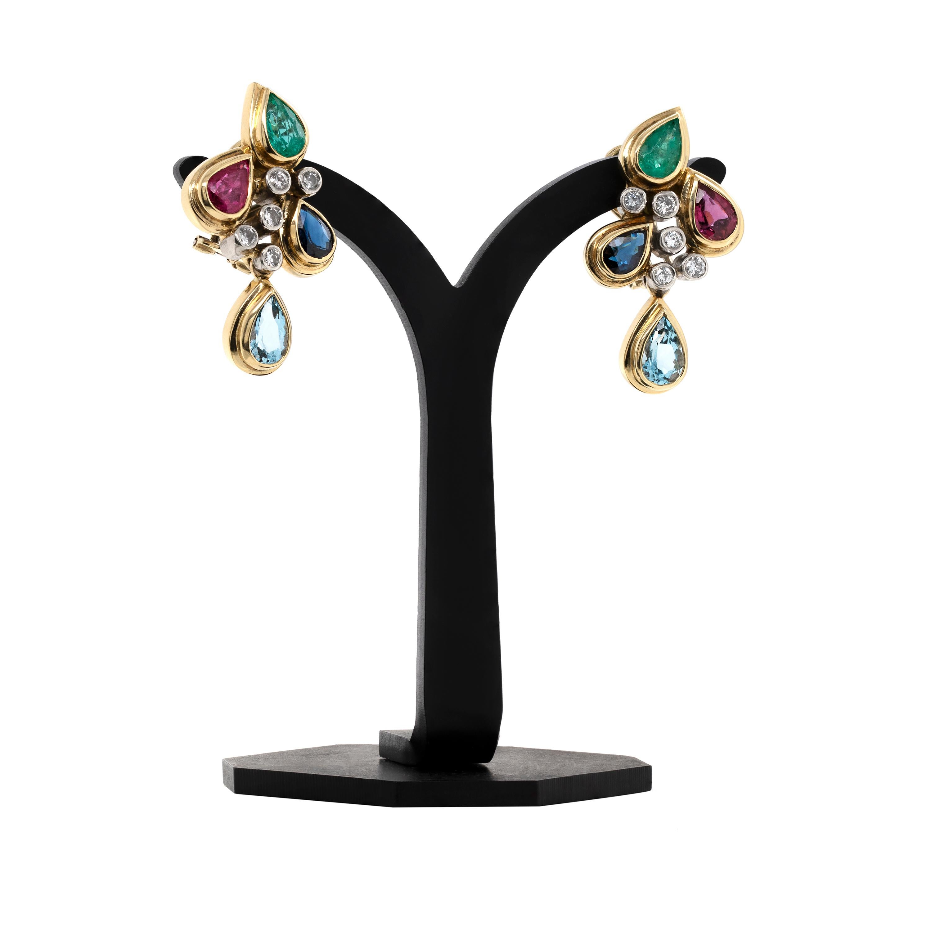 These beautiful clip-on cocktail cluster earrings feature a wonderful selection of coloured gemstones. Each earring is rubover set with a pear shaped ruby, blue sapphire, emerald and aquamarine estimating to weigh 0.50ct each. The earrings are