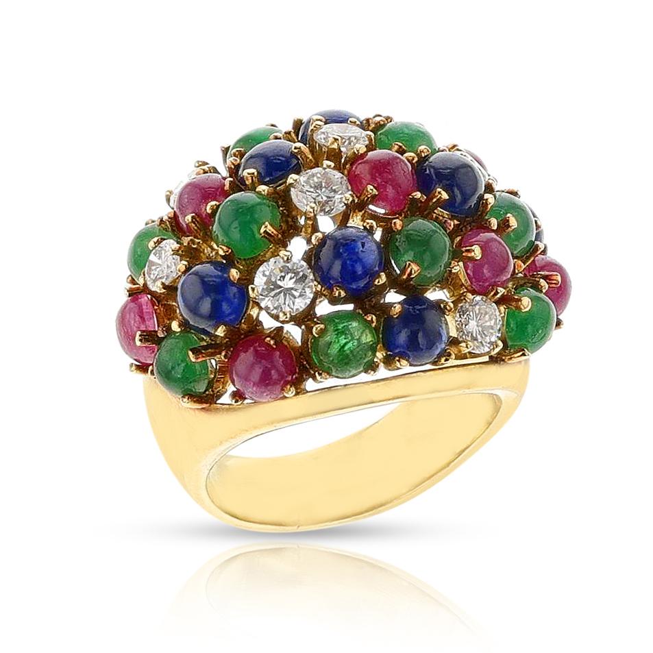 Bague bombe en or jaune 18 carats (émeraude, saphir, rubis cabochon et diamant). Les diamants pèsent environ 1 carat et les pierres de couleur environ 2,25 carats. Le poids total est de 17,28 grammes. La taille de la bague est de 6,50. 