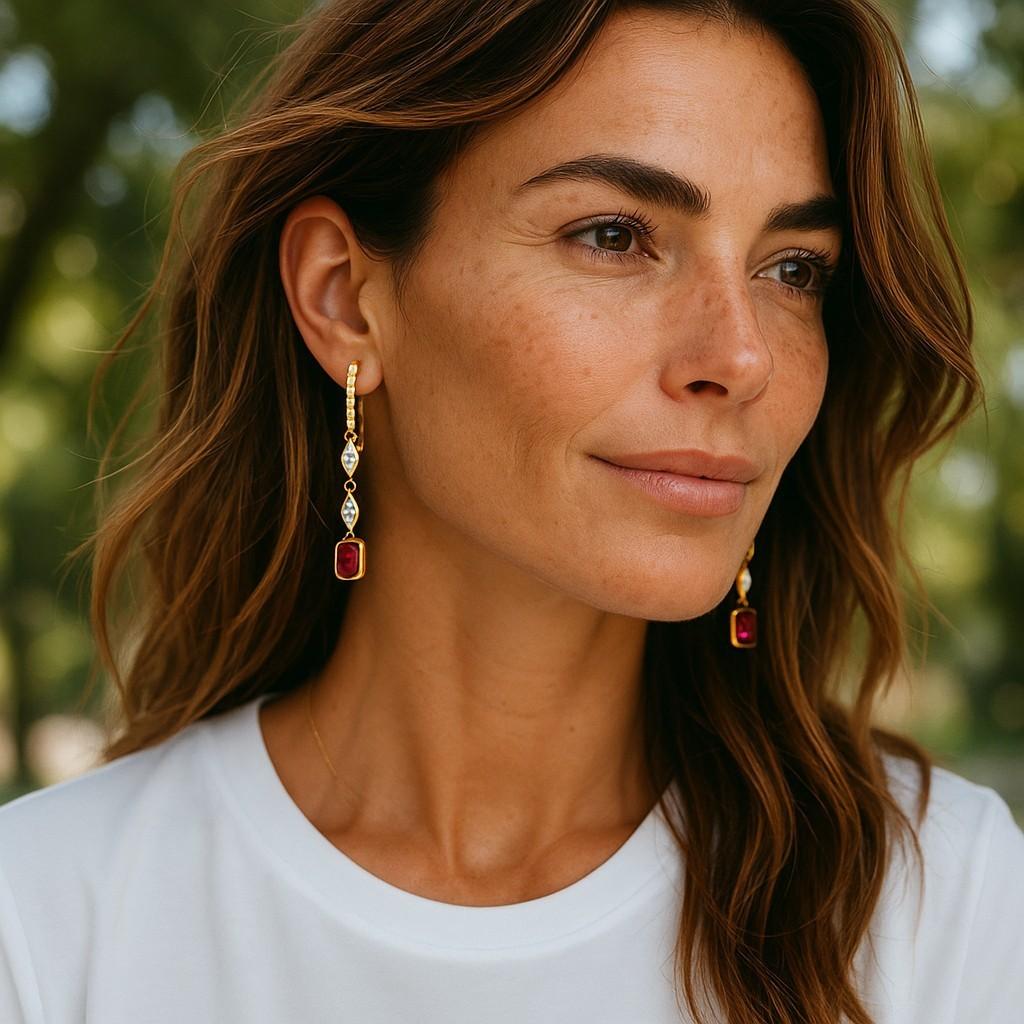 Introducing our stunning Emerald Shaped Ruby Gold Earrings, 14 karat yellow gold, a captivating blend of timeless elegance and modern sophistication. Crafted to perfection, these earrings are a true masterpiece, designed to elevate any ensemble with