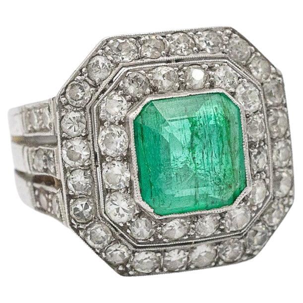 Emerald signet type ring ith an impressive emerald and diamonds