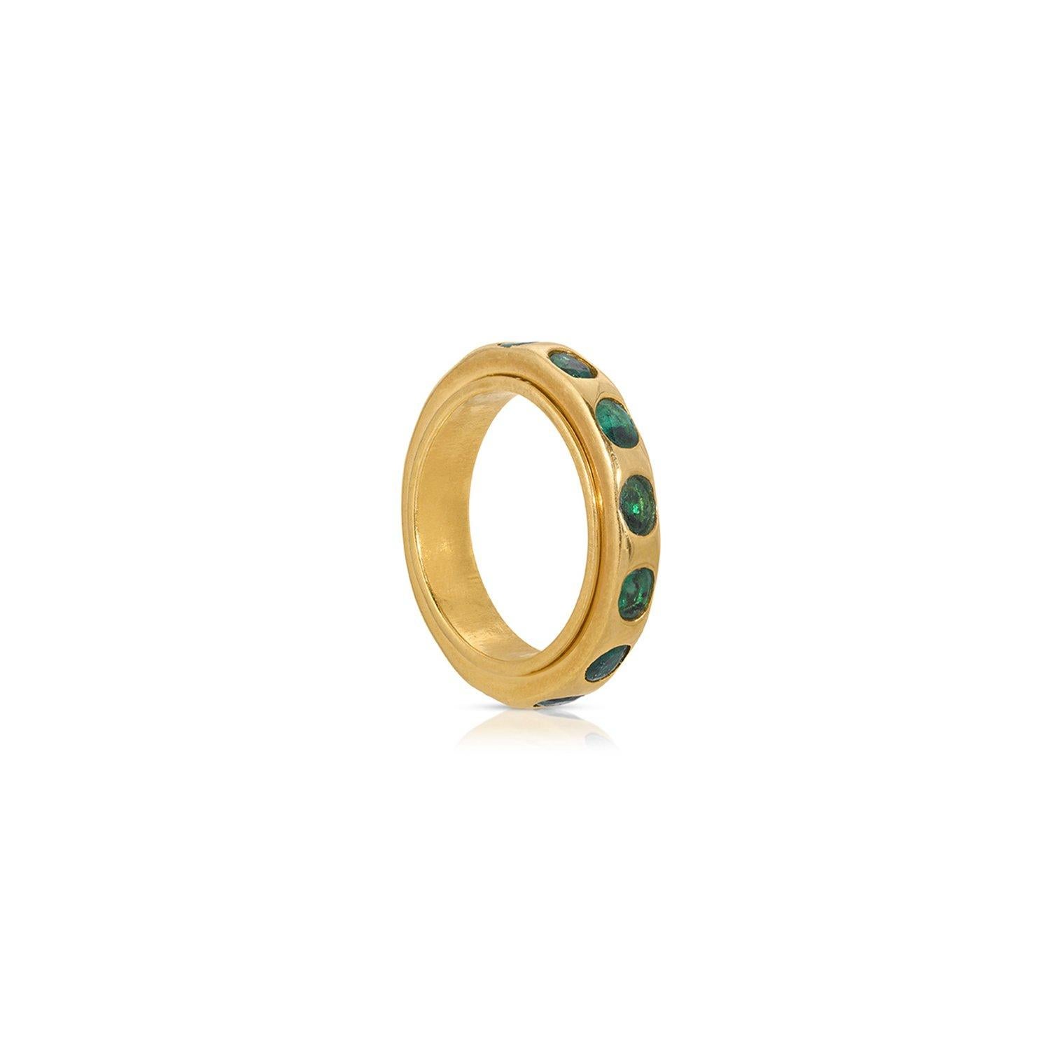 Emeralds set in a contemporary gold band featuring an outer revolving ring set with the fiery green gems.

- Natural Emeralds weight approx 1.89 Carats.
- Set in 22 Karat Gold overlay Silver.