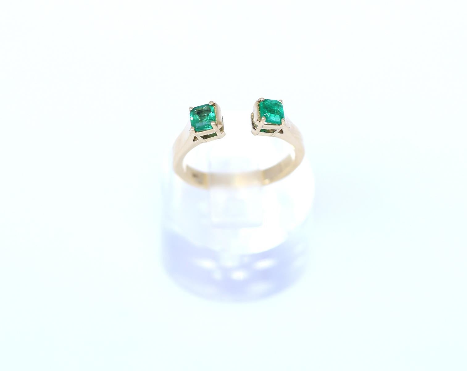 Two square-cut fine casting Emeralds on 18K Yellow Gold Ring horseshoe shape.
Very unusual design when two square-shaped Emeralds are embracing a finger. When looking from above it feels like they are levitating around the finger. Modern design yet