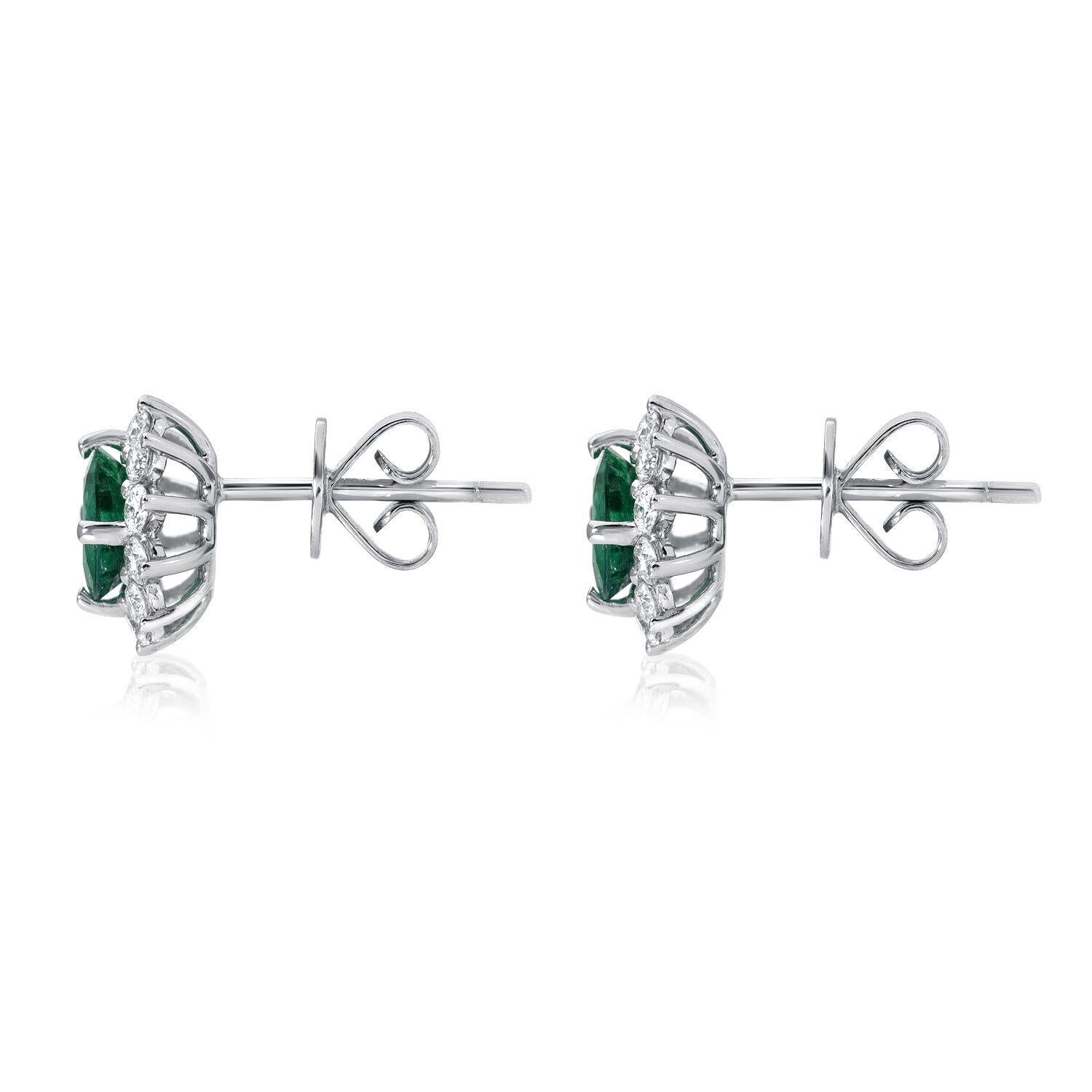 Emerald earrings featuring a pair of 1.29 carats total round Emeralds, framed by a total of 0.62 carat total round brilliant diamonds, in 18K white gold stud earrings.

Returns are accepted and paid by us within 7 days of delivery.

Emerald is the