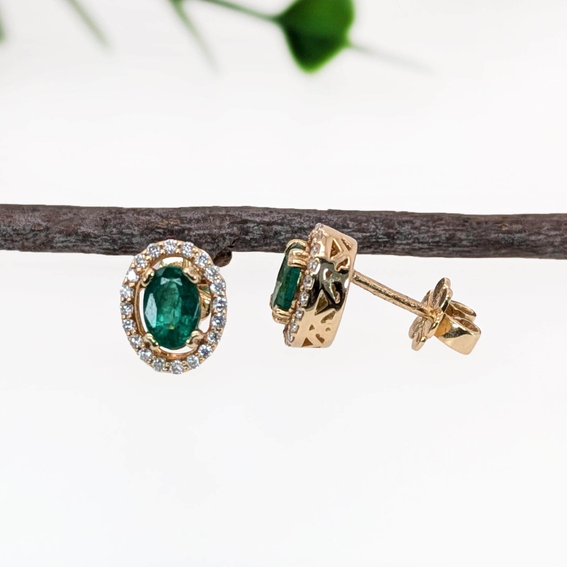 This sparkling earring set features a pair of vibrant earth mined emeralds with a pave diamond halo in solid 14k gold. A stunning pair of stud earrings designed perfectly for an eye catching engagement or anniversary. These earrings also make a