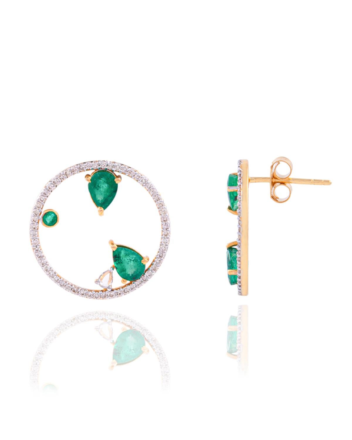 These earrings are made with Emerald gemstones and diamond. They are set in 14K gold. Shine all day long in this delicate pair of stud earrings. Perfect for gifting, they twinkle with timeless elegance. Easy to mix and match with other jewellery