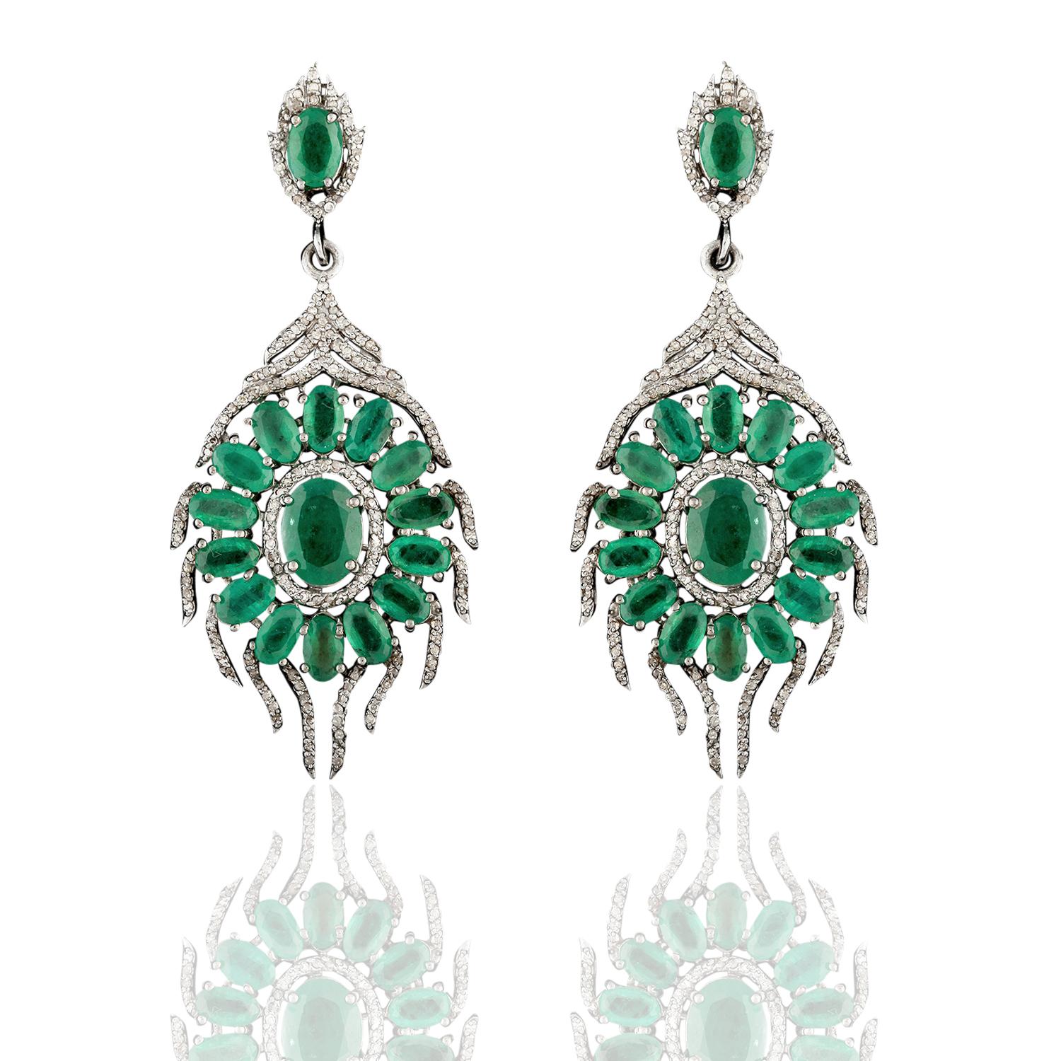 Beautifully & delicately crafted on silver and 14kt gold with 8.58 carat of emeralds & 1.60 carat of single cut diamonds.

Silver: 6.964 grams; 14kt gold: 0.9 grams.

5 cm in full length. Very light weight for pierced ears.