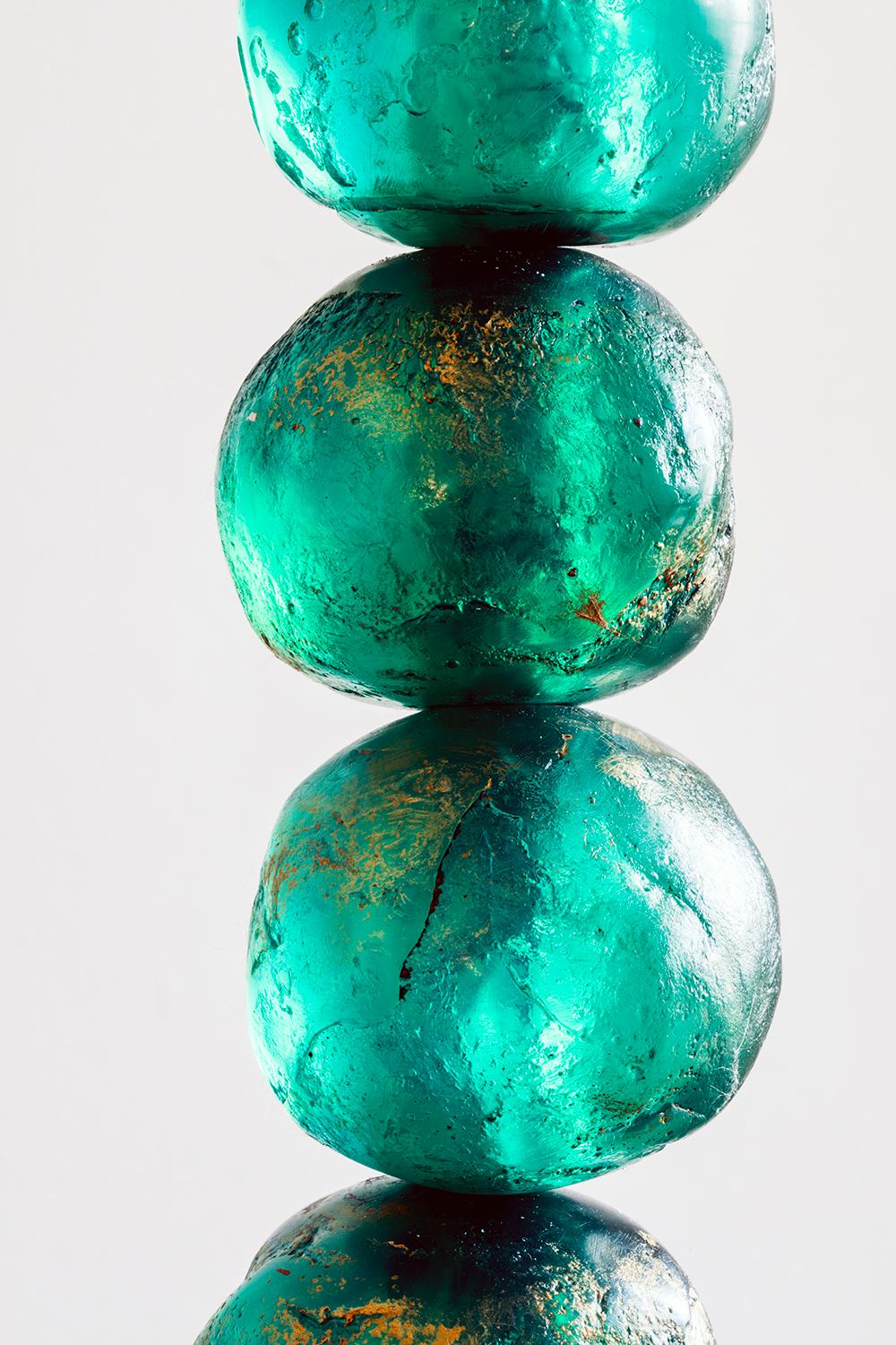 This Margit Wittig vibrant emerald with gold-leaf patina table lamp features multiple translucent resin hand-cast spheres and semi-circles. The hint of gold patina enhances the organic surface textures which are interspersed with two brass details,