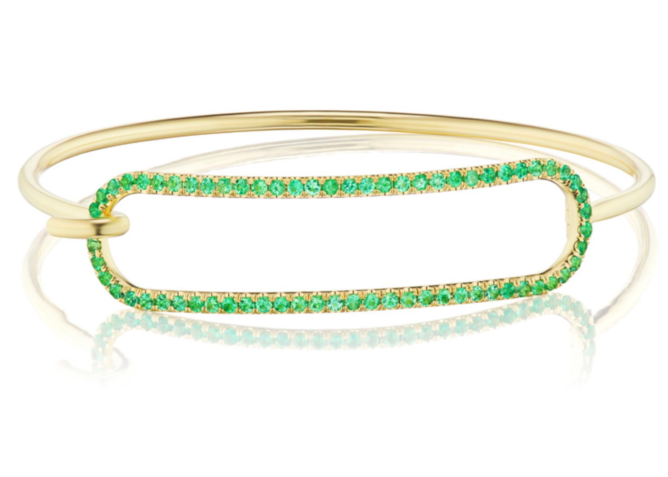 Andrew Glassford's signature 2mm Emerald Tension Bracelet in 18K yellow gold with .98 carats of round Emeralds that creates a stunning 