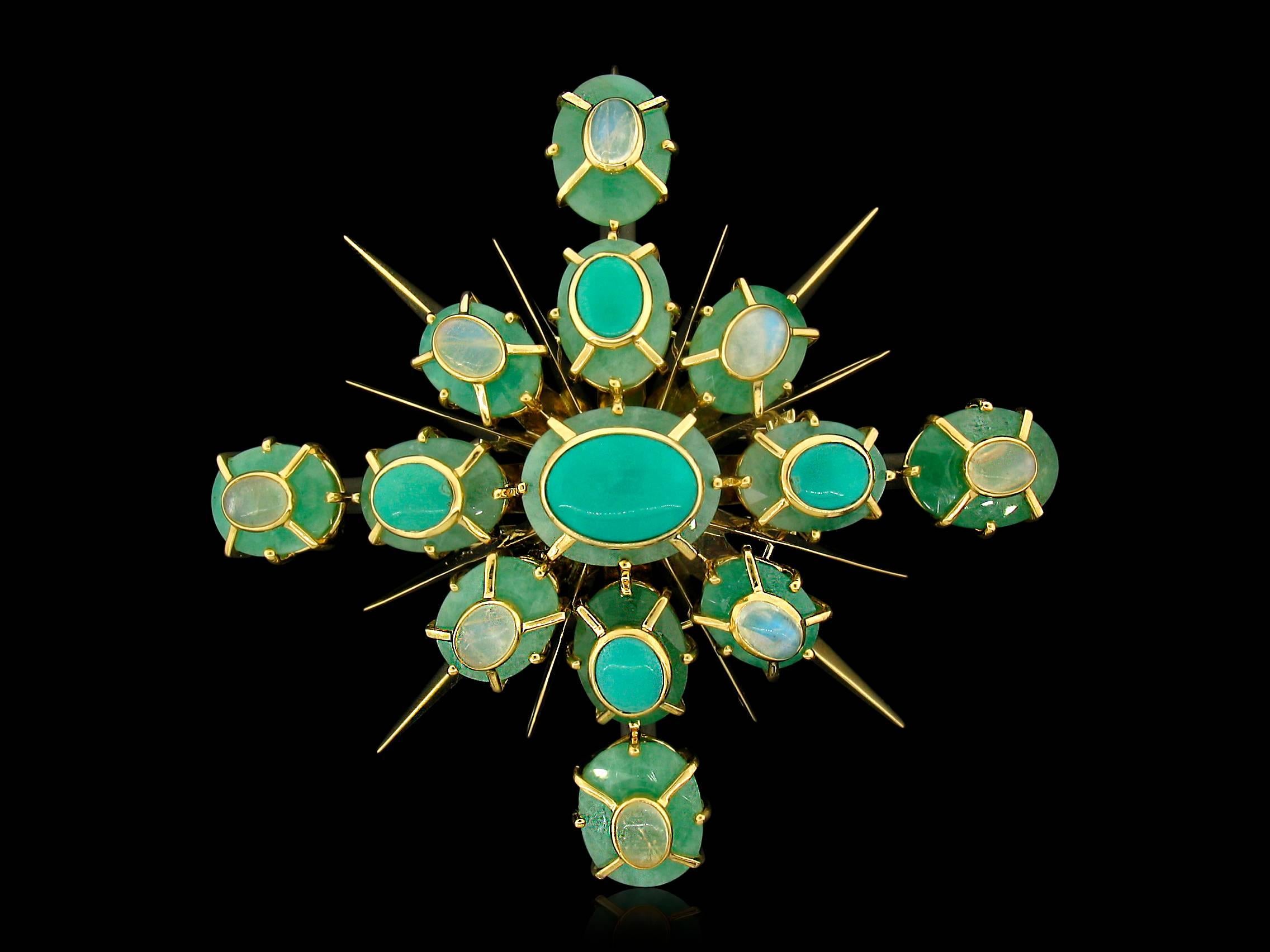 This Tony Duquette Starburst creation features oval Turquoise weighing 8.60 carats and Moonstones weighing 6.80 carats set atop Emeralds weighing a total of 98 carats. 18k yellow gold. This may be worn as a Brooch, or the pin can accommodate a chain